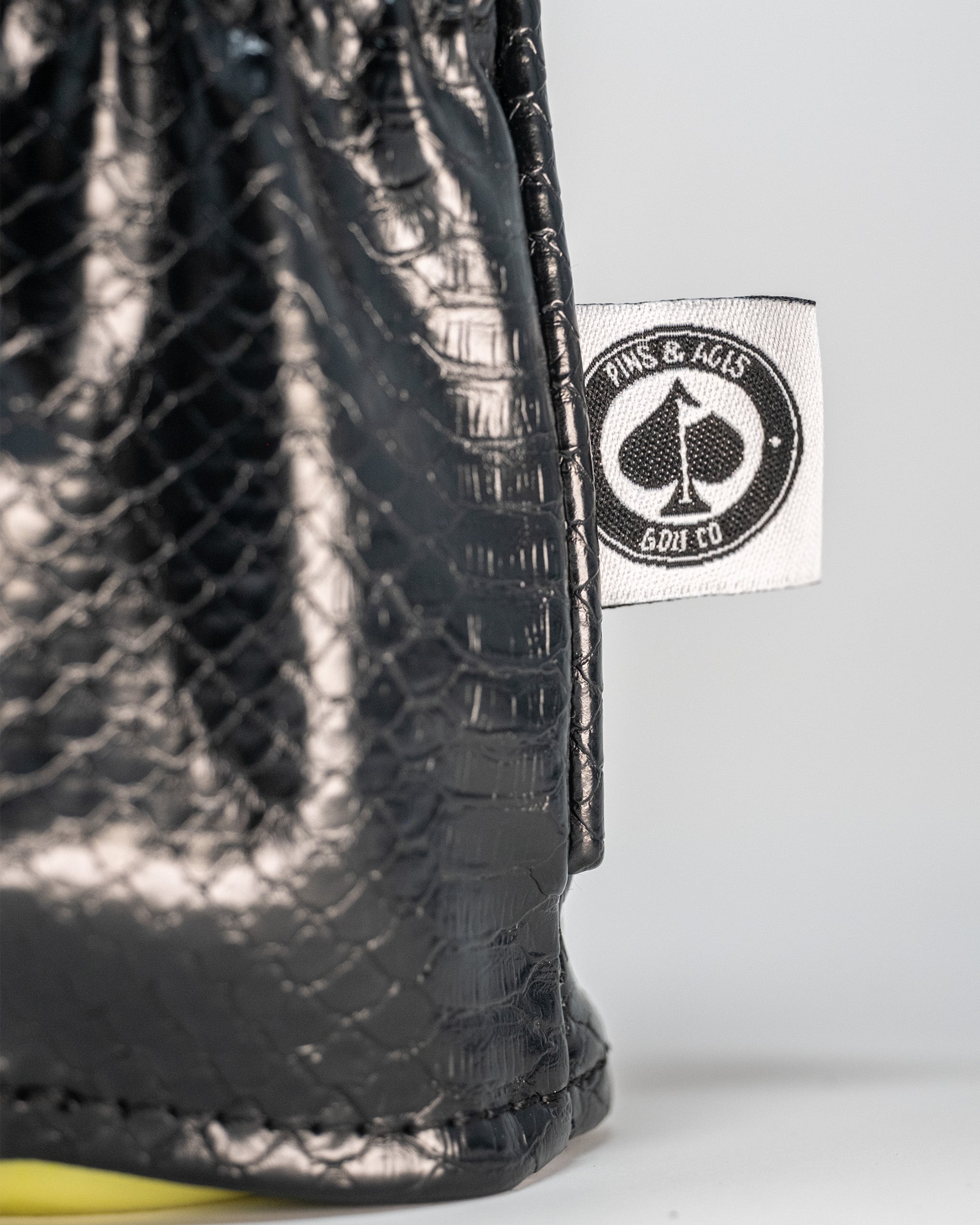 Venom Driver Cover featuring a sleek black snake-skin design and Pins and Aces logo for stylish golf protection.