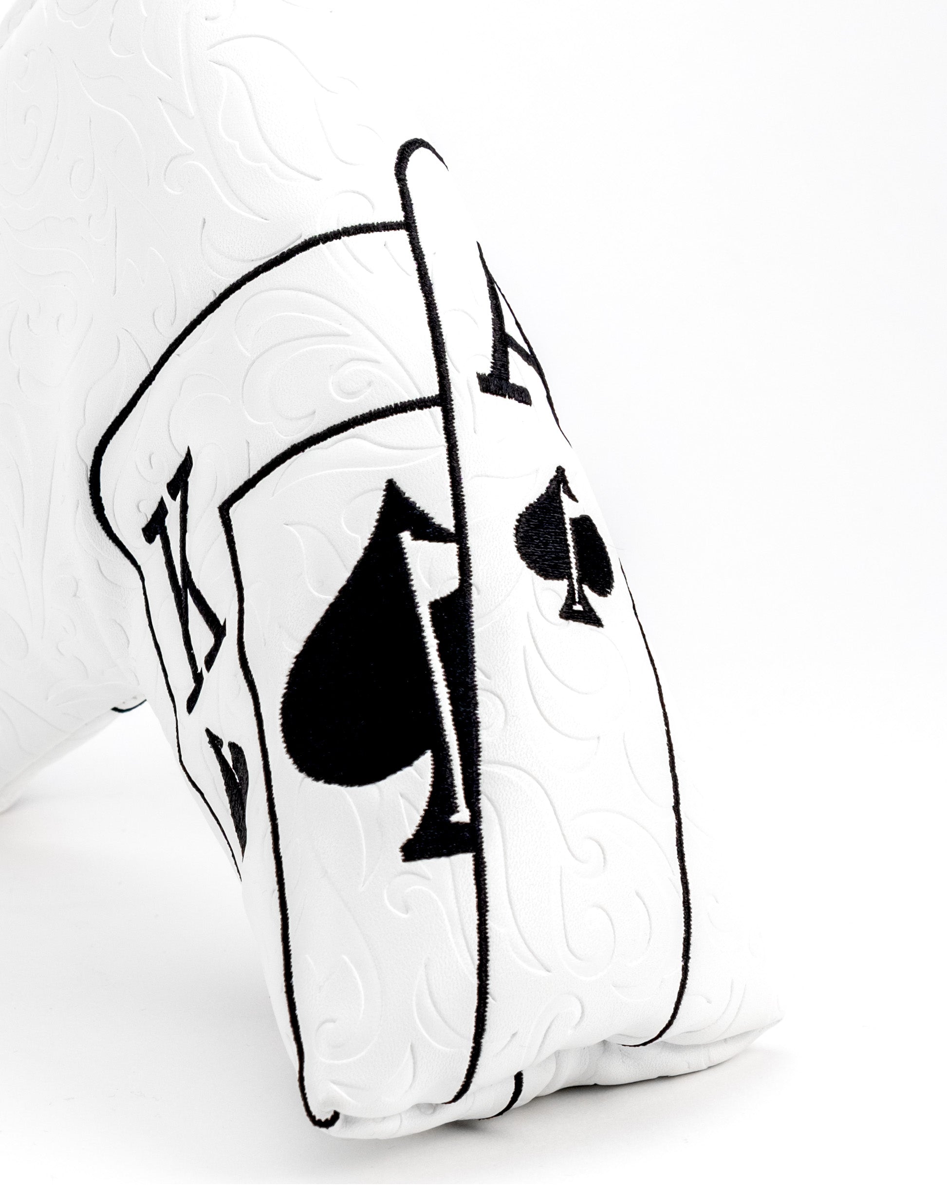 White putter cover featuring an Ace of Spades design with intricate black embroidery, perfect for stylish golfers.