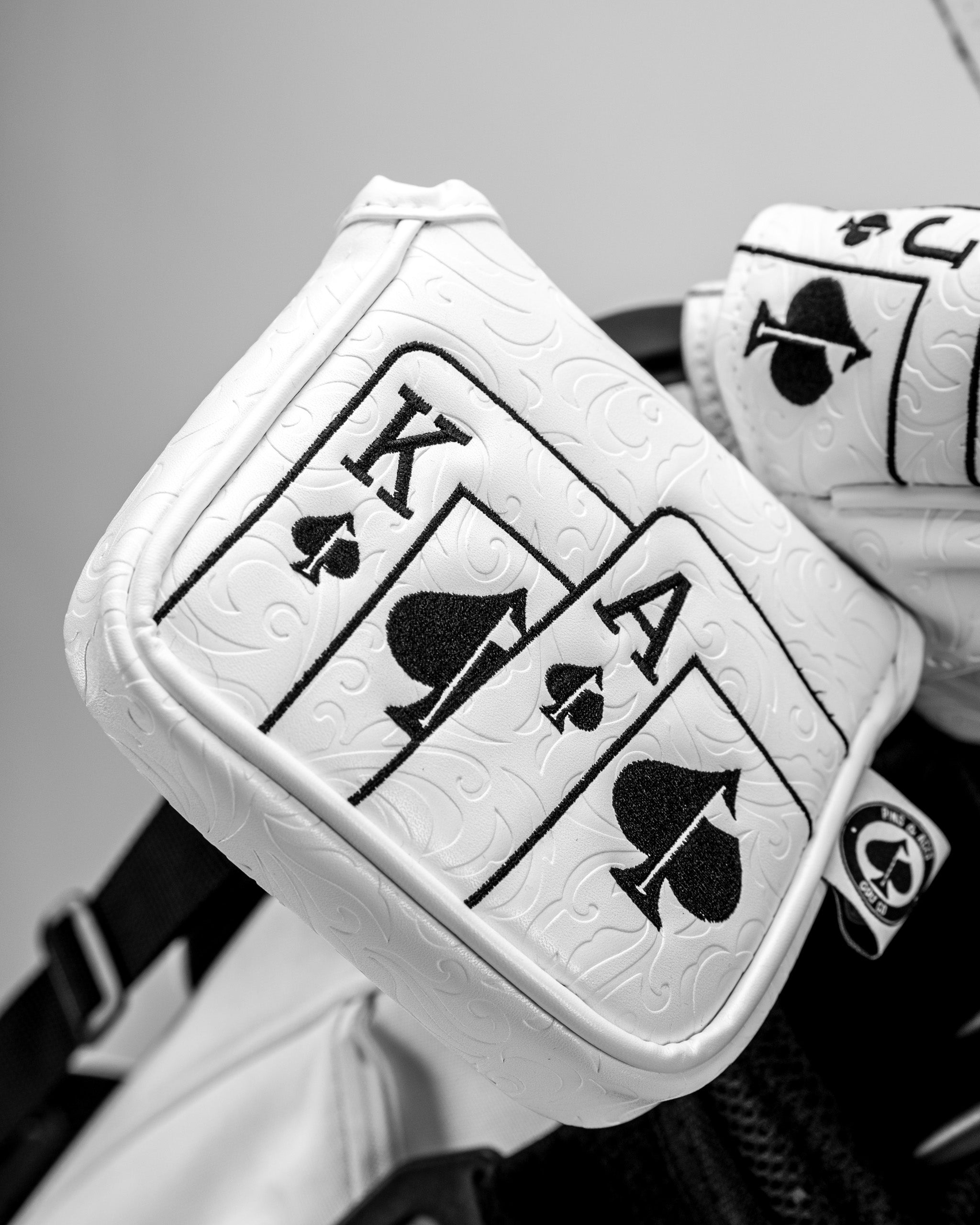 White Out Ace of Spades mallet putter cover featuring embossed playing cards design for stylish golf accessories.
