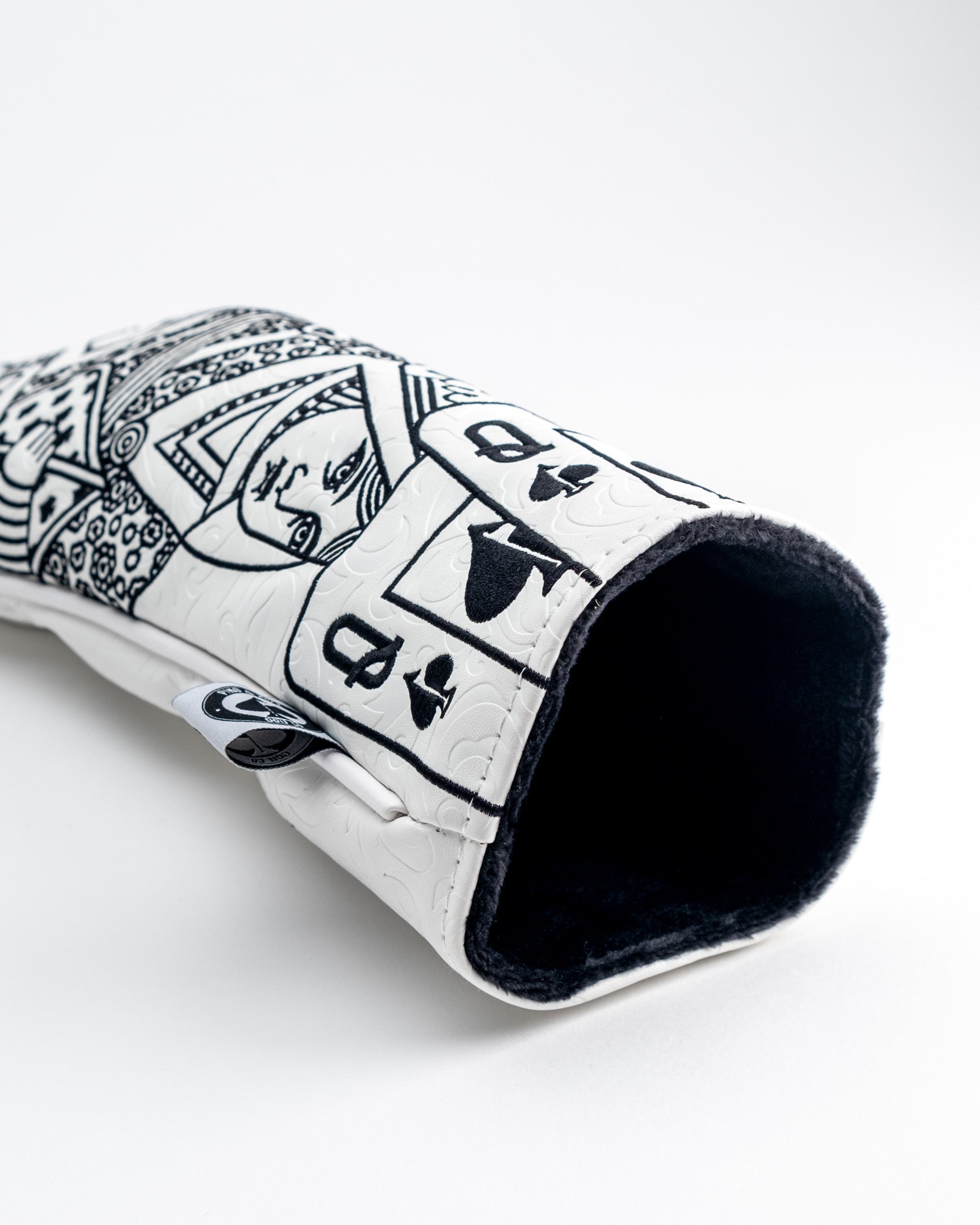White Out Queen of Spades fairway cover featuring intricate black and white designs for a bold golf accessory.