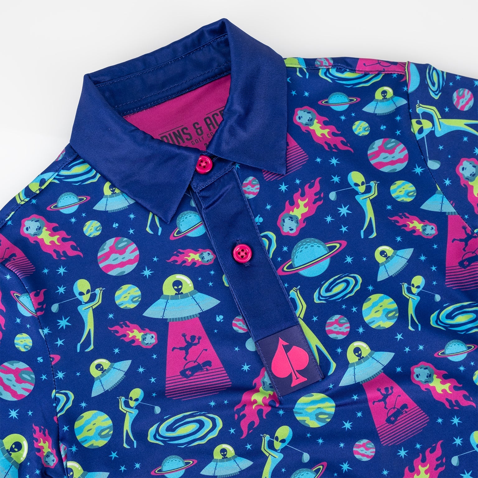 Youth Alien Invasion Polo featuring a vibrant design with aliens, spaceships, and planets on a blue background.