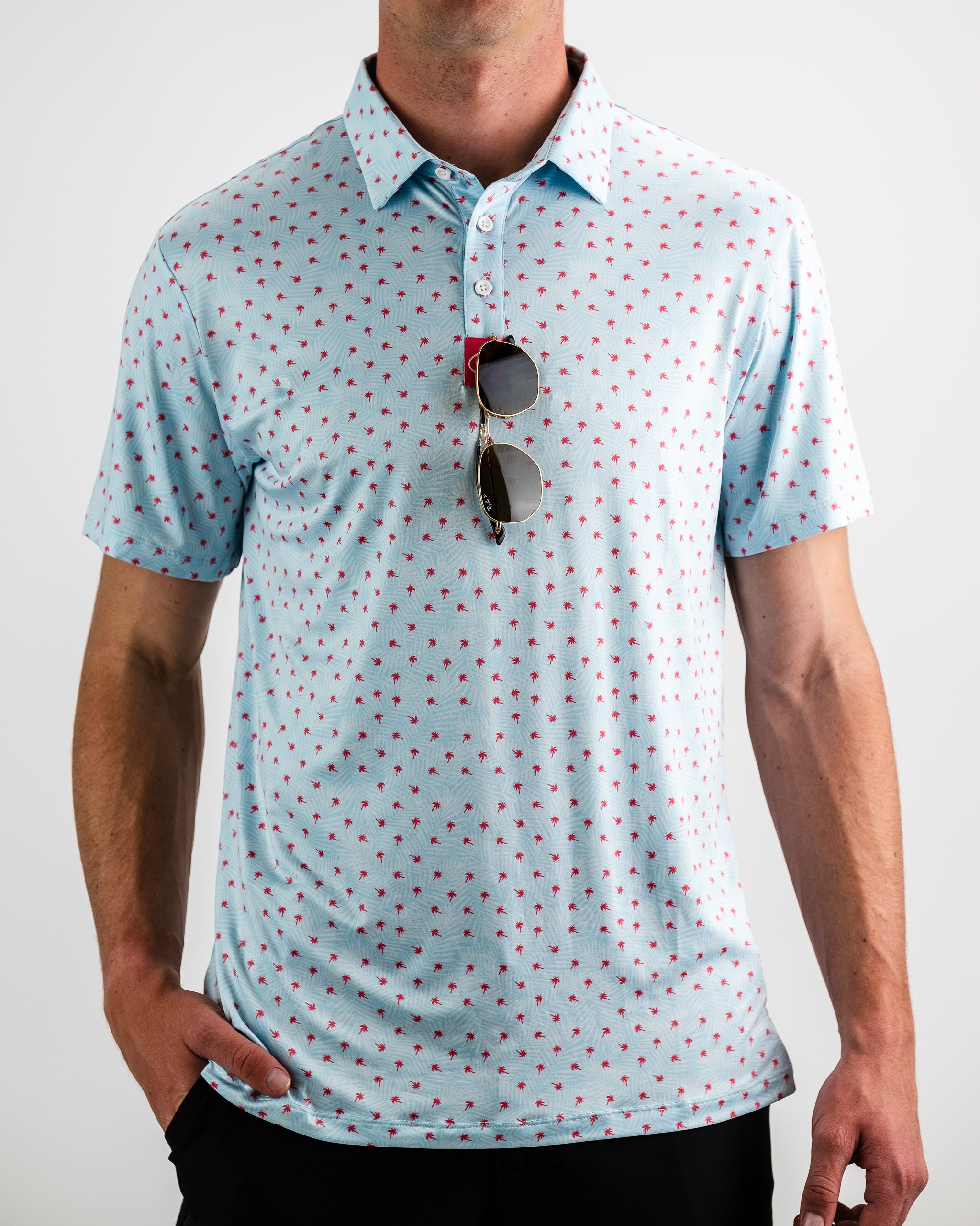 Model wearing a blue dress with palm leaf prints, styled for Palm Sunday.