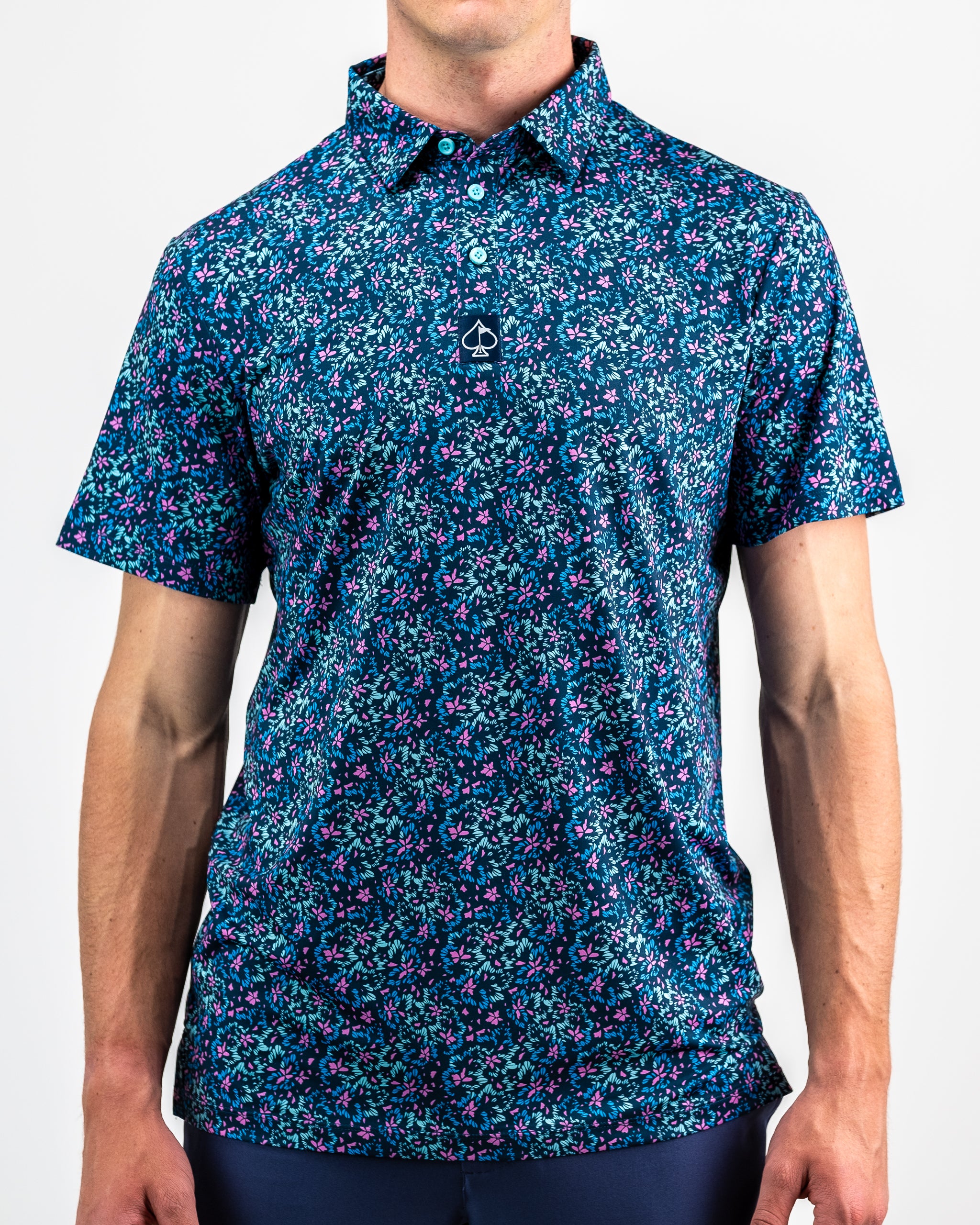 Fluorescent floral print dress on a model, featuring vibrant colors and a fitted silhouette against a neutral background.