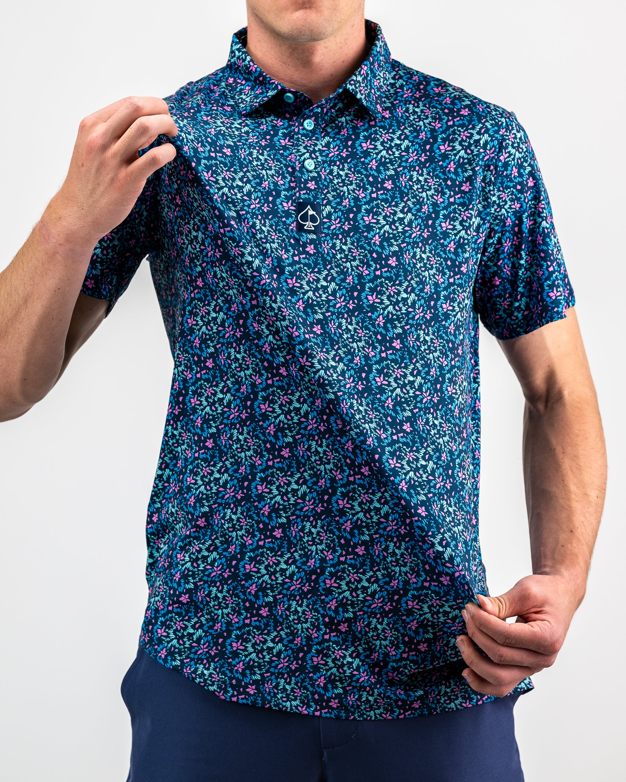 Fluorescent floral dress displayed on a model, featuring vibrant colors and a flowy silhouette against a light background.