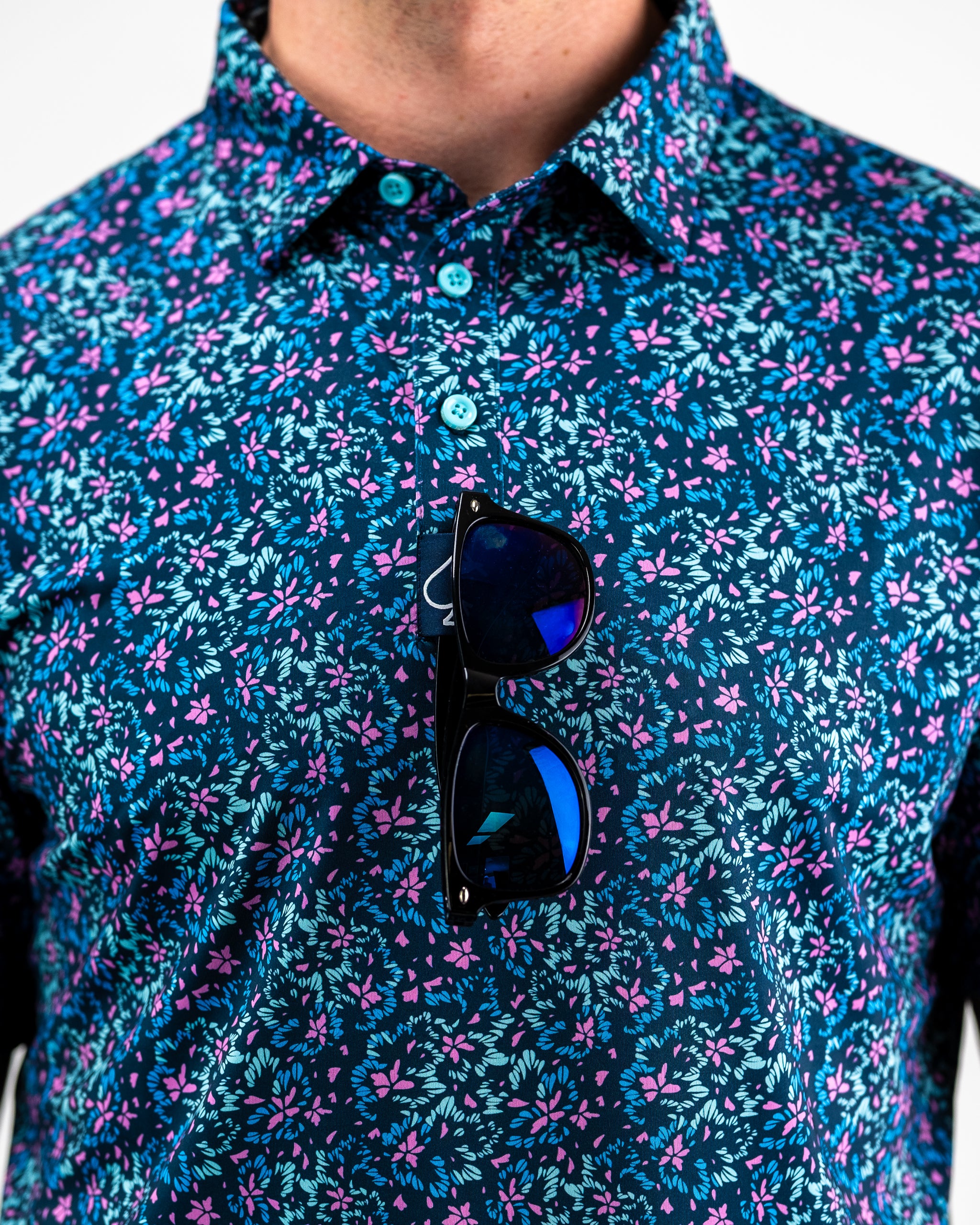 Brightly colored fluorescent floral dress with a vibrant pattern on a model, showcasing a spring/summer style.