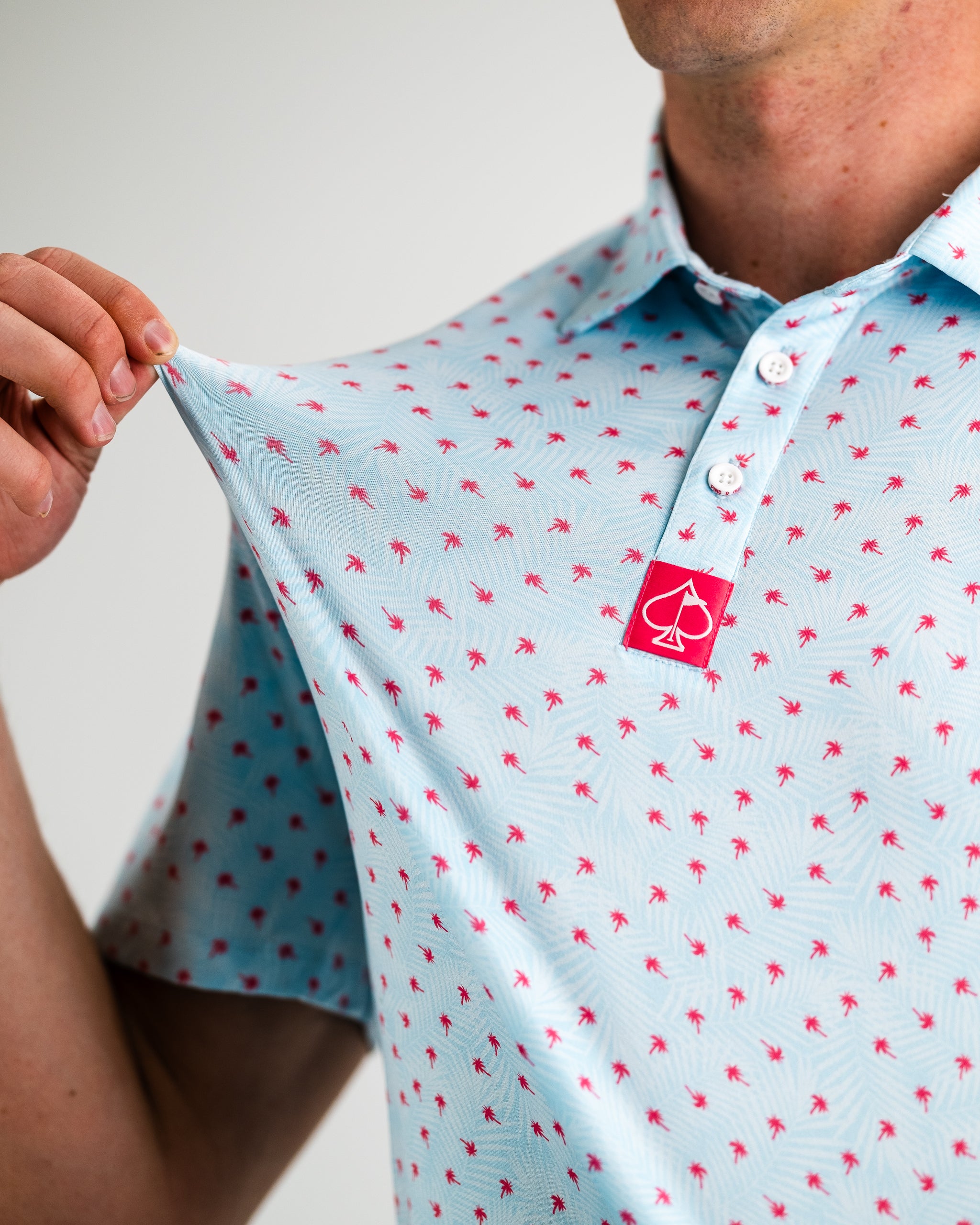 Palm Sunday Blue dress with floral patterns, displayed on a model outdoors.