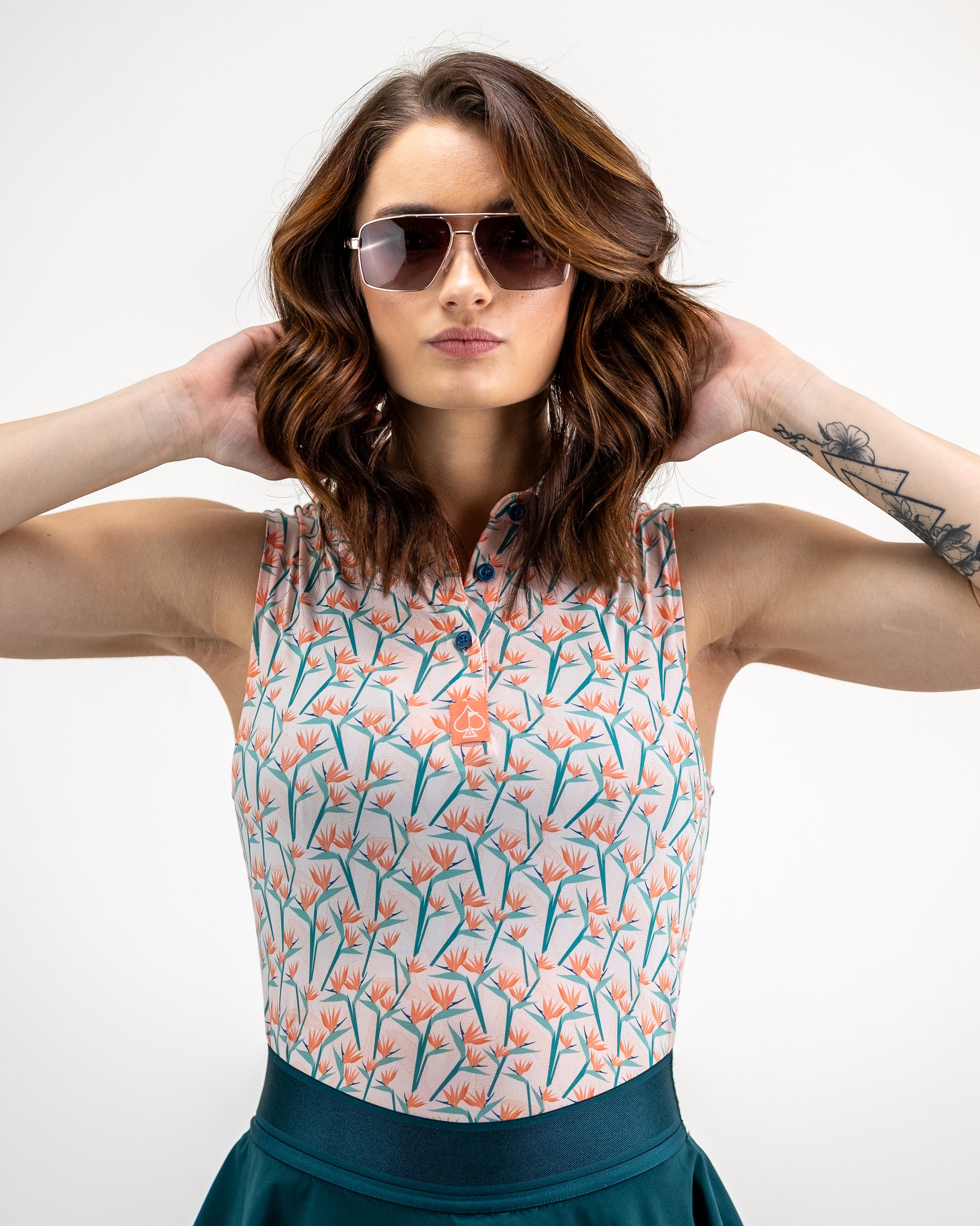 Women's Birds of Paradise dress featuring a vibrant floral print, short sleeves, and a flattering silhouette, modeled outdoors.