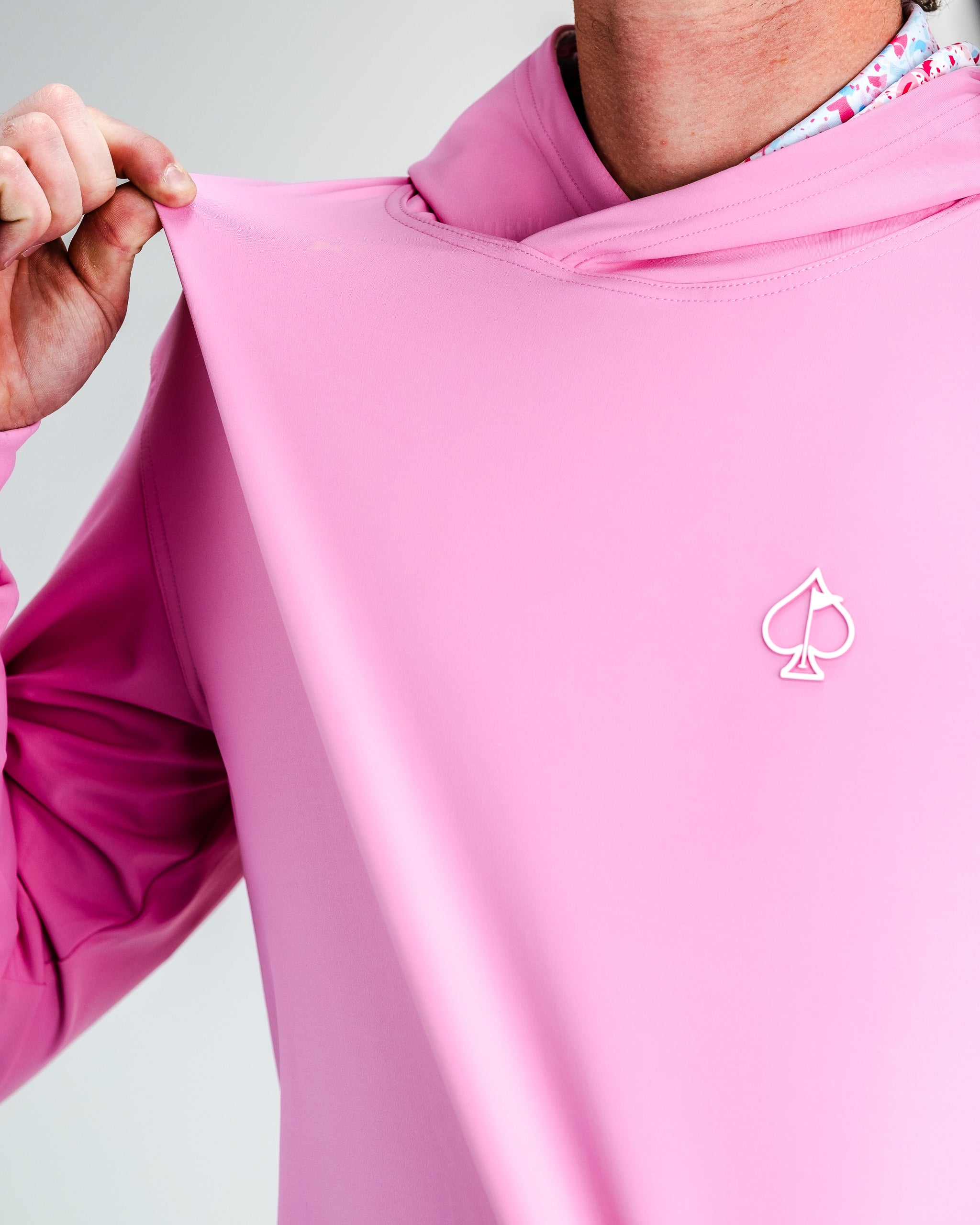 Performance golf hoodie in Flamingo Shatter design, featuring a vibrant pattern and comfortable fit, perfect for on-course style.