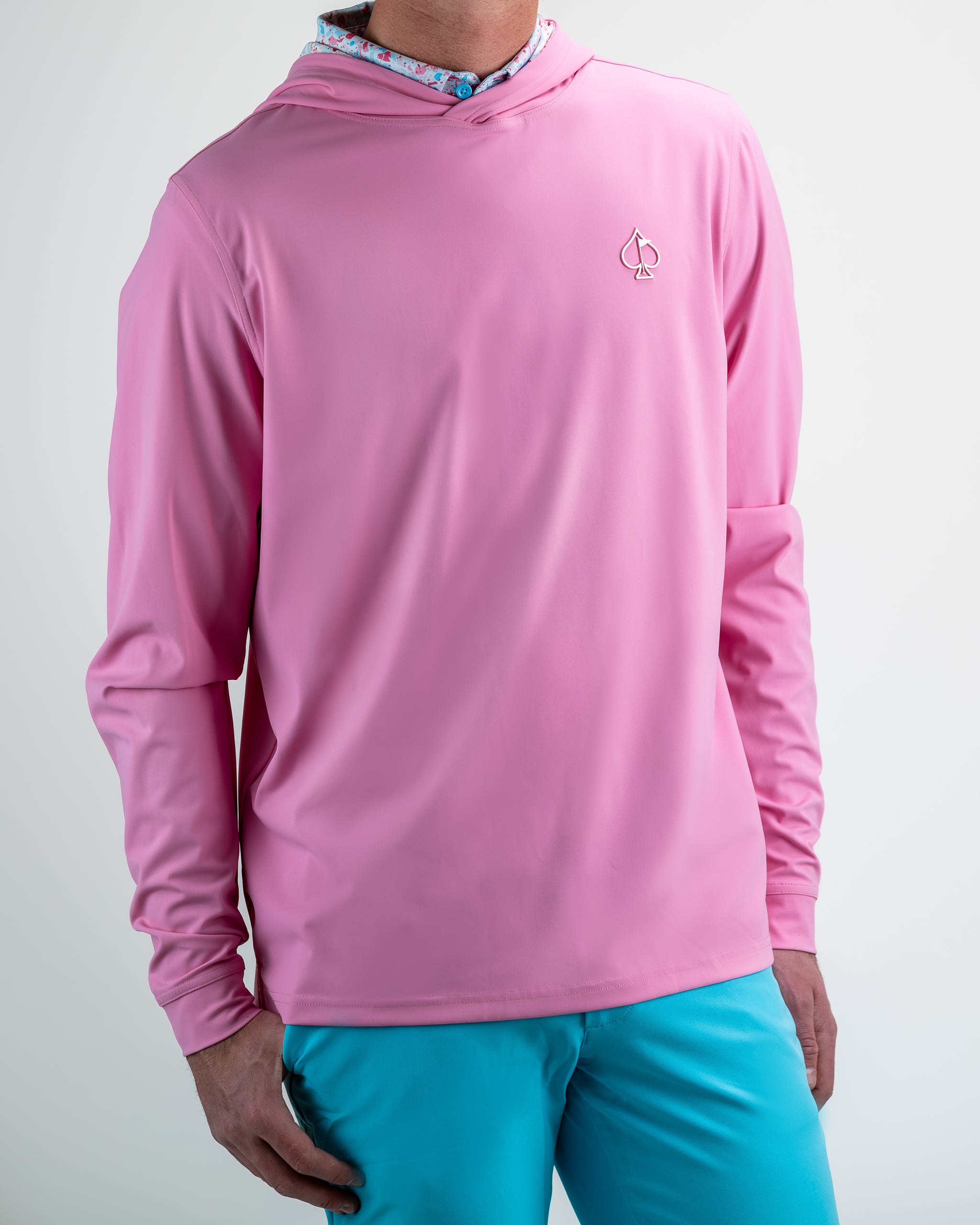 Performance Golf Hoodie in Flamingo Shatter design worn by a model, showcasing vibrant pink and black abstract patterns.