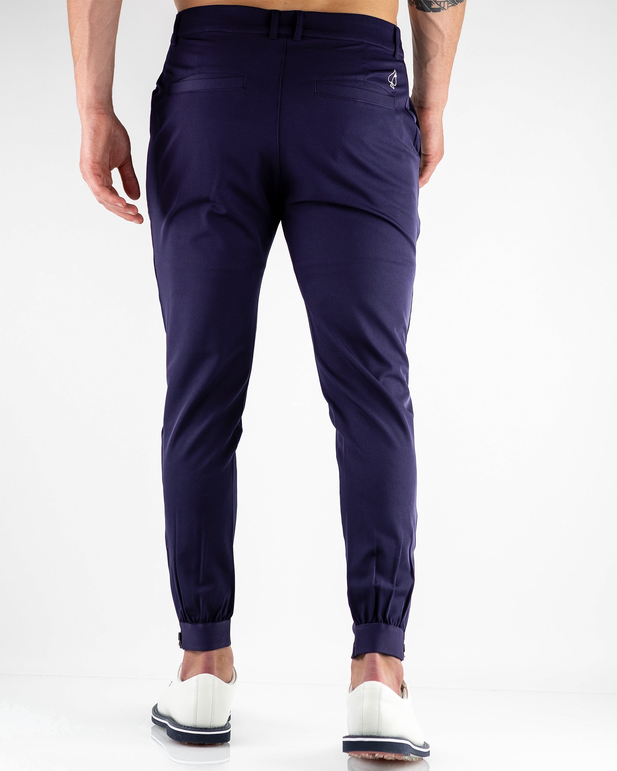 Navy performance jogger featuring a slim fit and elastic waistband, modeled in a casual outdoor setting.