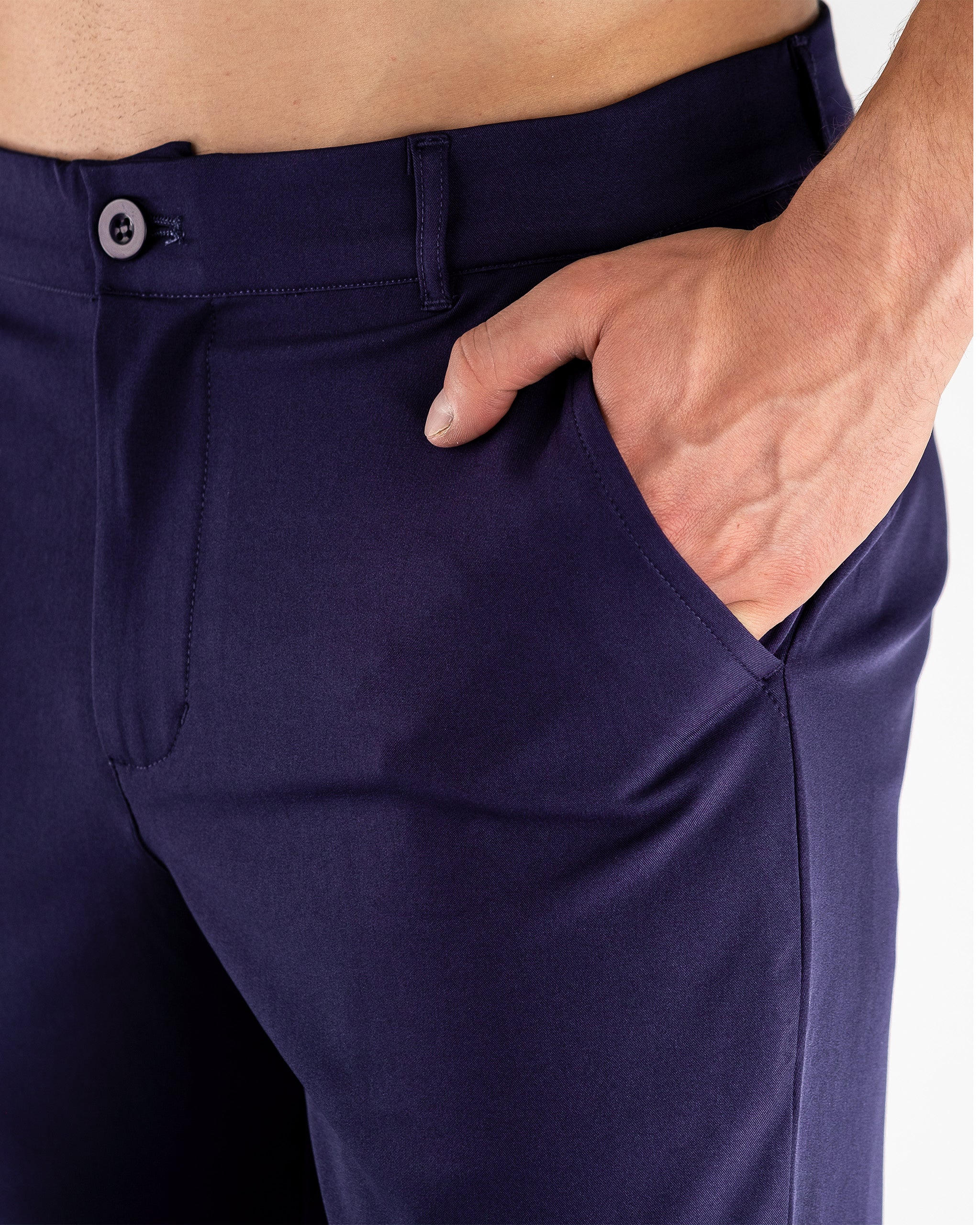 Navy performance jogger featuring a tapered fit and adjustable waistband, displayed on a model in an outdoor setting.