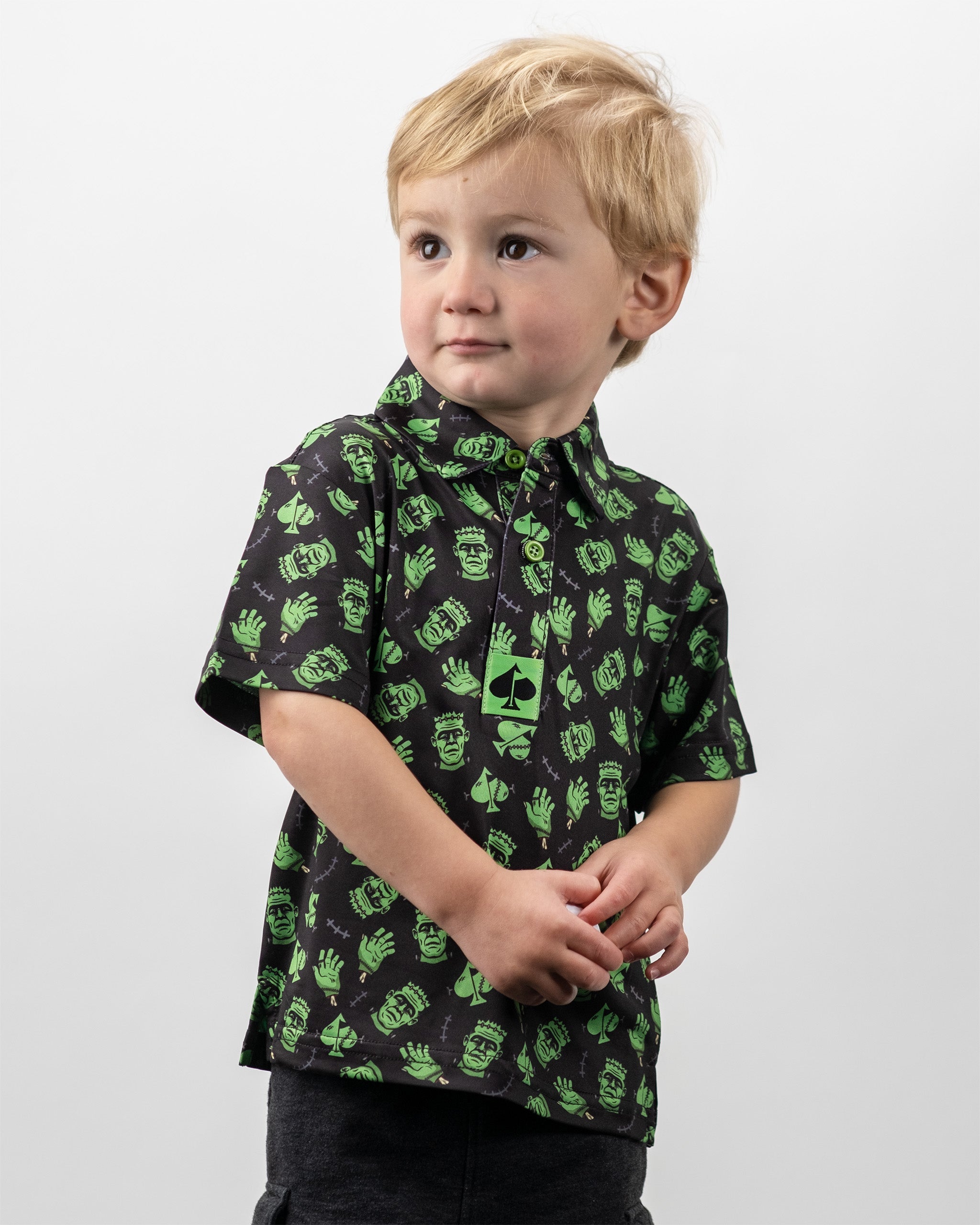 Youth Frankenstein Polo featuring a playful green and black design with monster motifs, perfect for young golfers.
