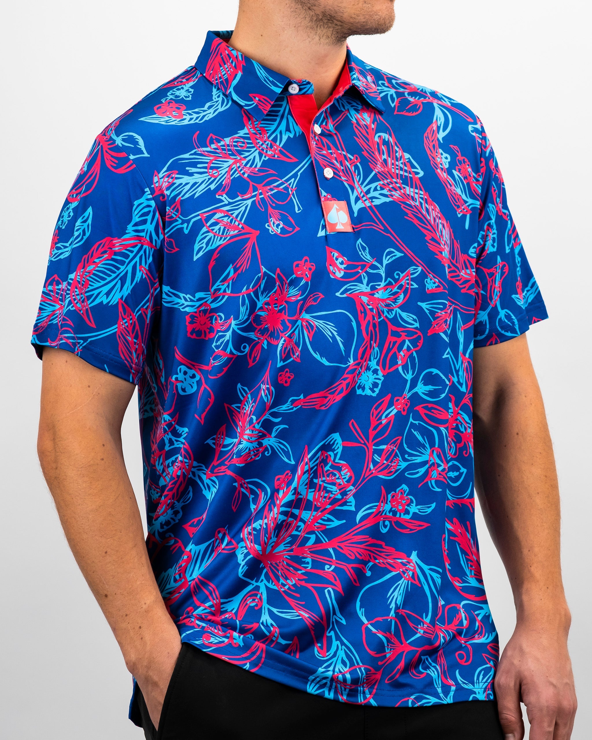 Bold blue golf polo featuring vibrant pink floral and leaf patterns, designed for golfers who want to stand out on the course.