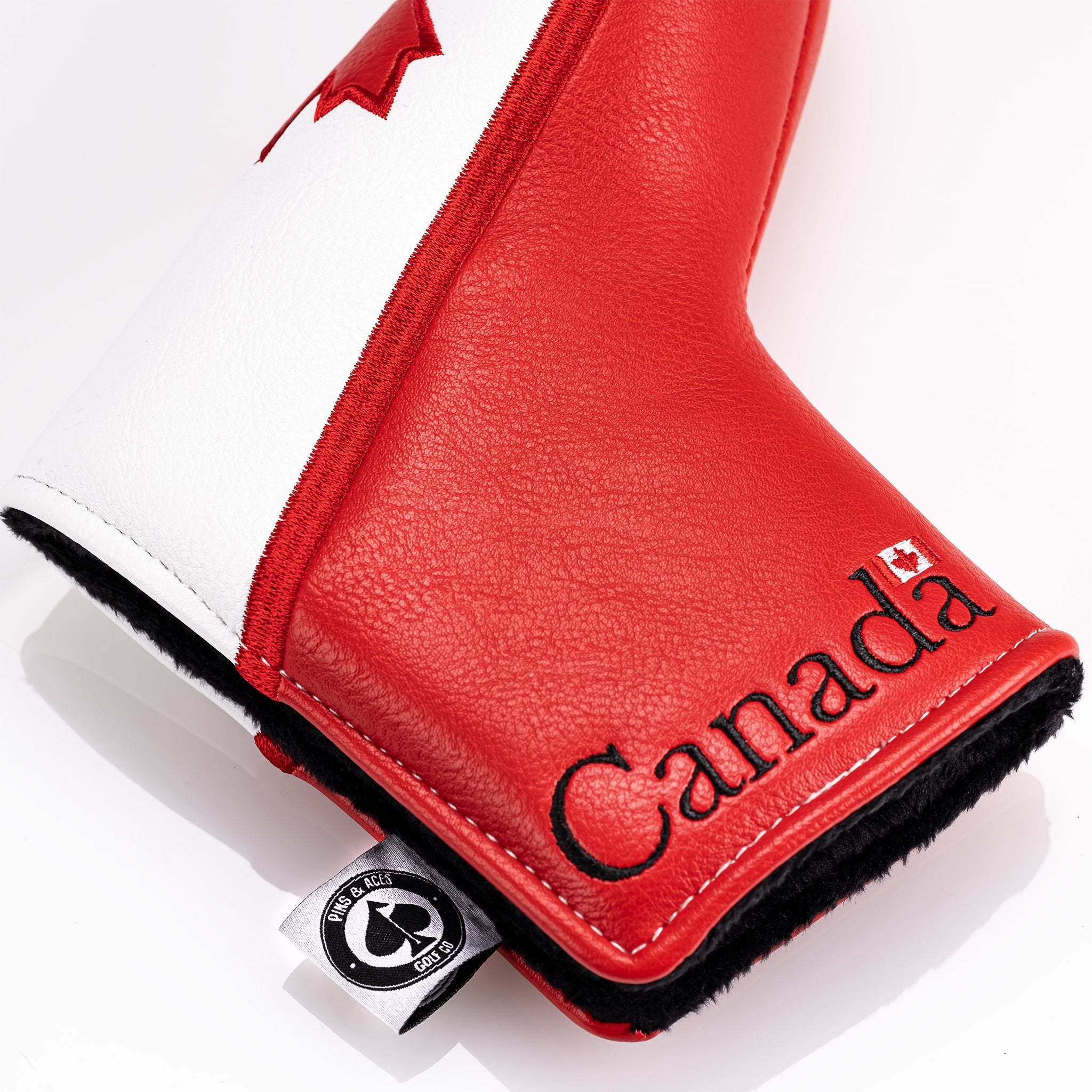 Bold red and white Canada blade putter cover featuring a textured finish and embroidered "Canada" for stylish golf protection.