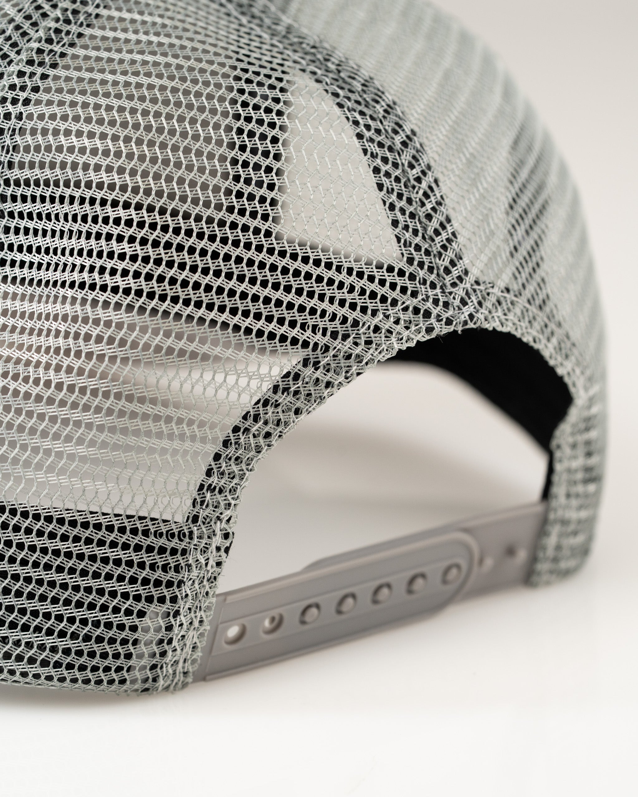 Trucker hat featuring Arctic camo design with a breathable mesh back and adjustable snap closure for comfort.