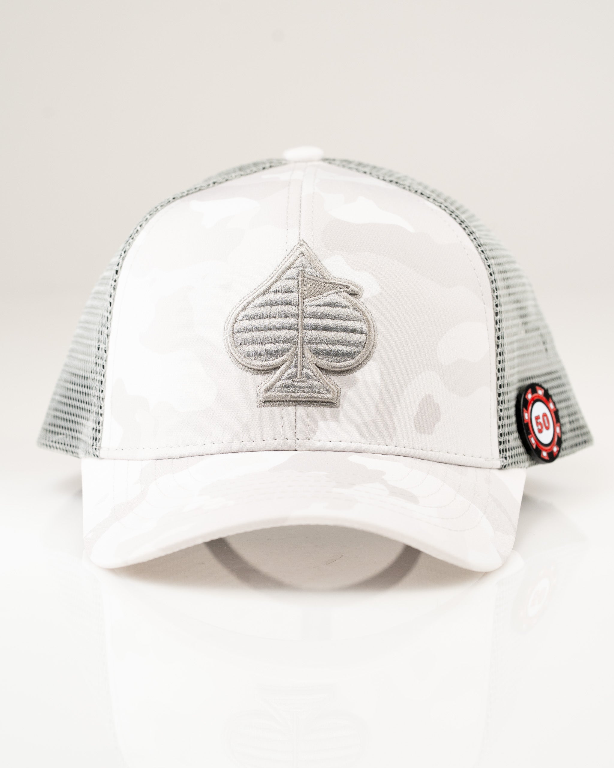 Trucker hat in Arctic Camo featuring a gray spade logo and mesh back for breathability and style on the golf course.