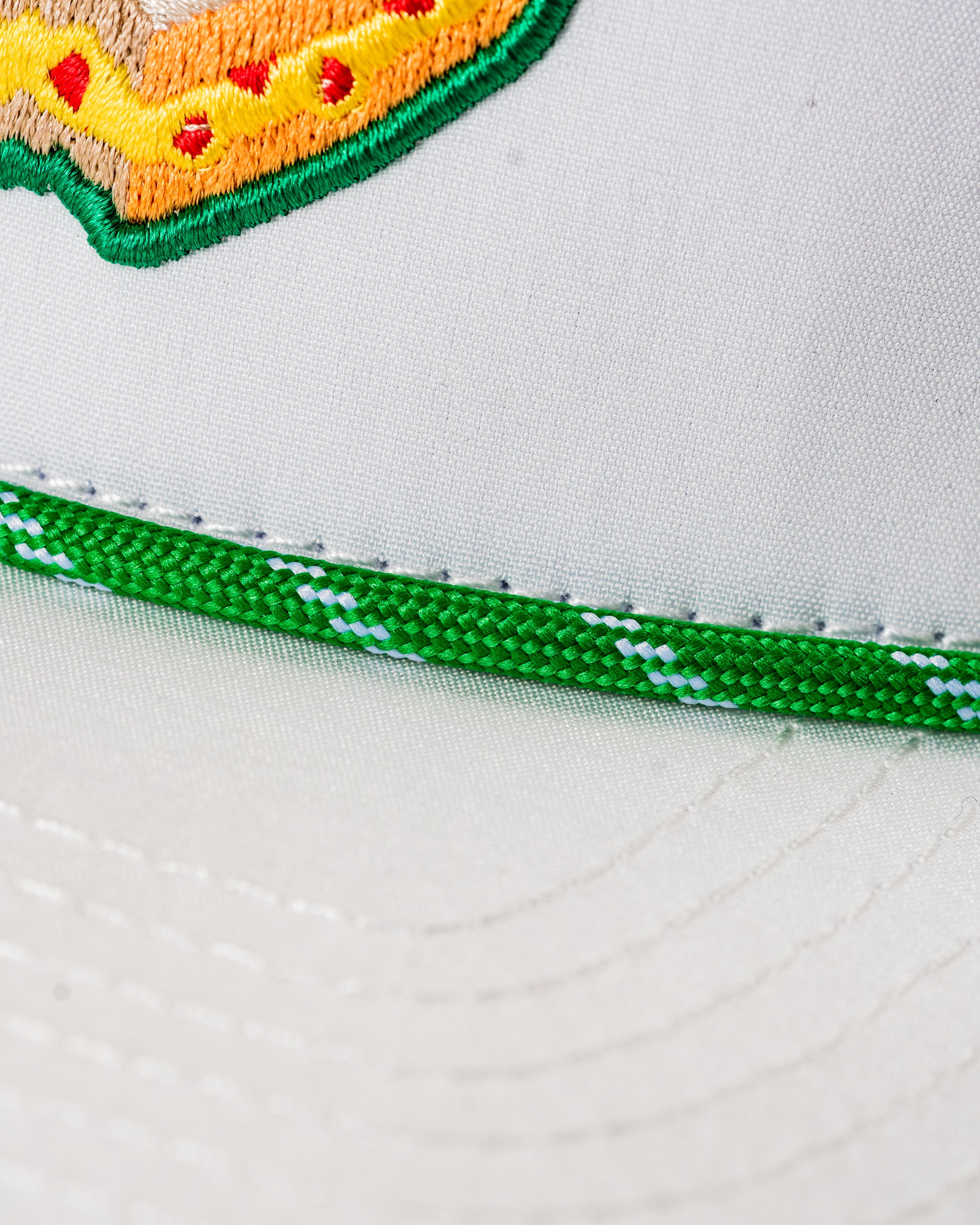 Perforated white rope hat featuring a colorful pimento cheese sandwich design on the front. Ideal for stylish golfers.