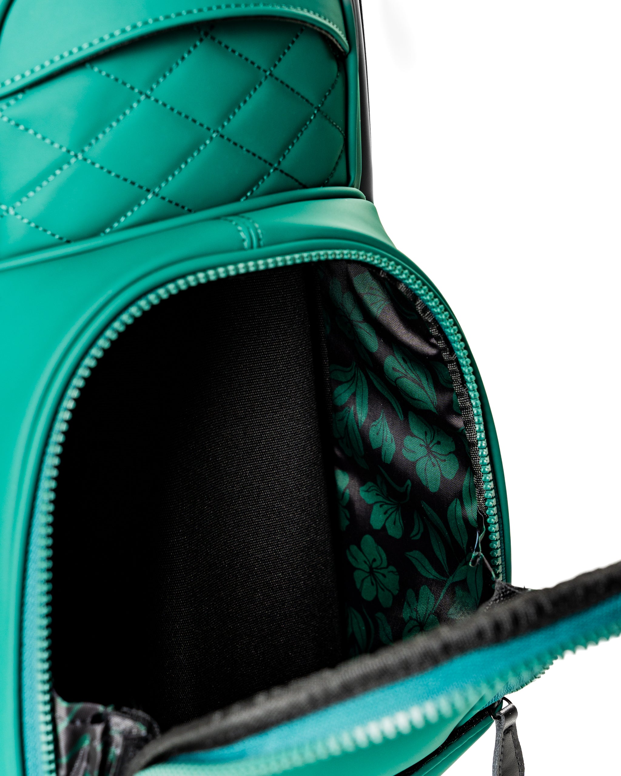 Interior view of the Player Preferred Golf Bag in teal, featuring a floral-patterned lining and a zippered pocket.