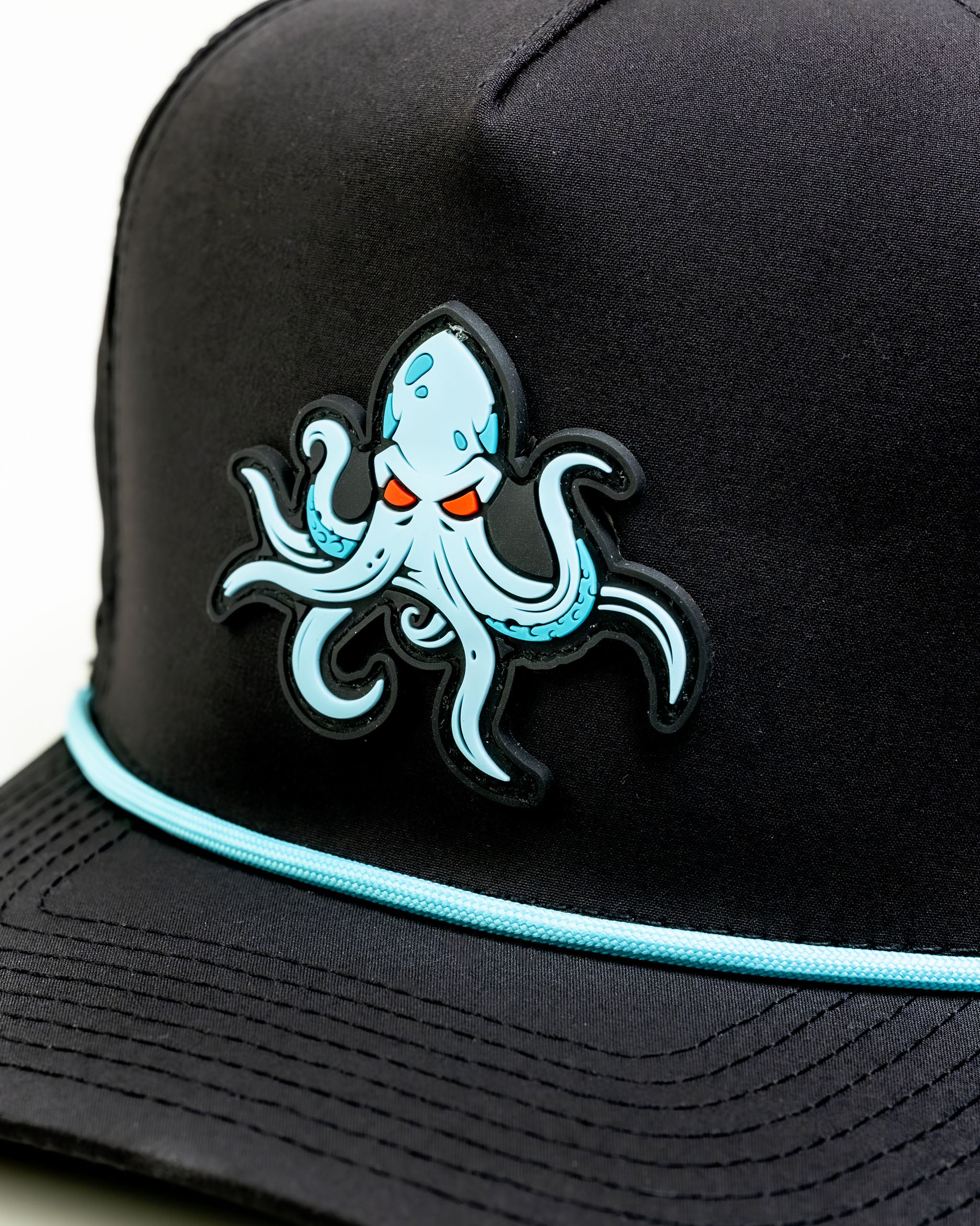 Black cap featuring a bold Kraken octopus design with blue accents and a light blue trim on the brim.