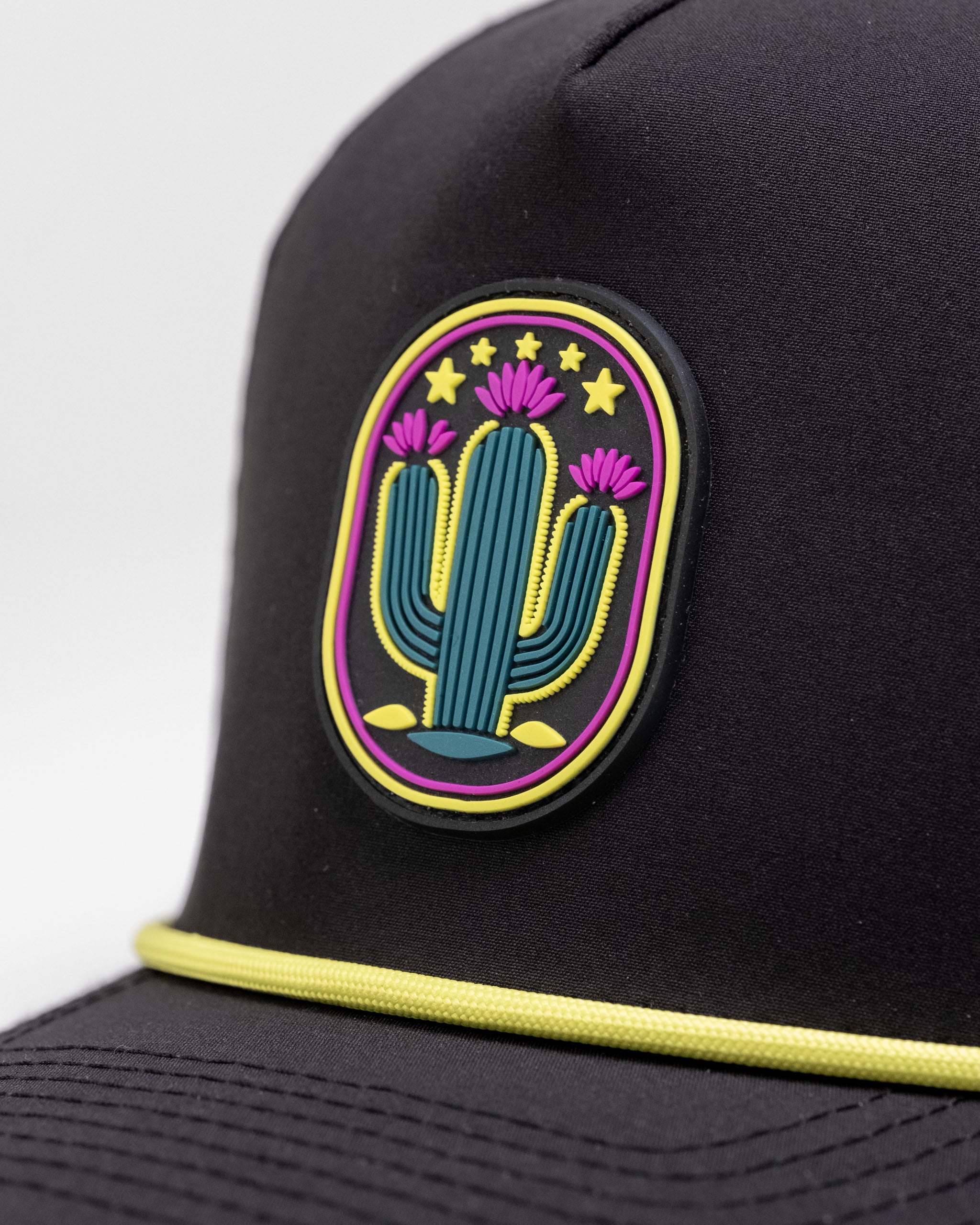 Cactus Black perforated rope hat featuring a colorful cactus patch with pink flowers and a vibrant design.