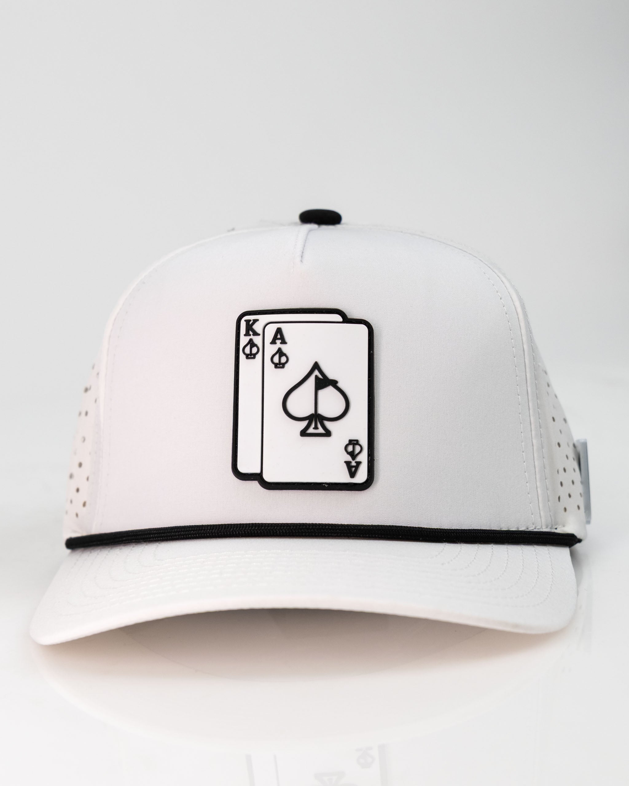 White perforated rope hat featuring a black ace and king playing card design on the front for a stylish golf look.