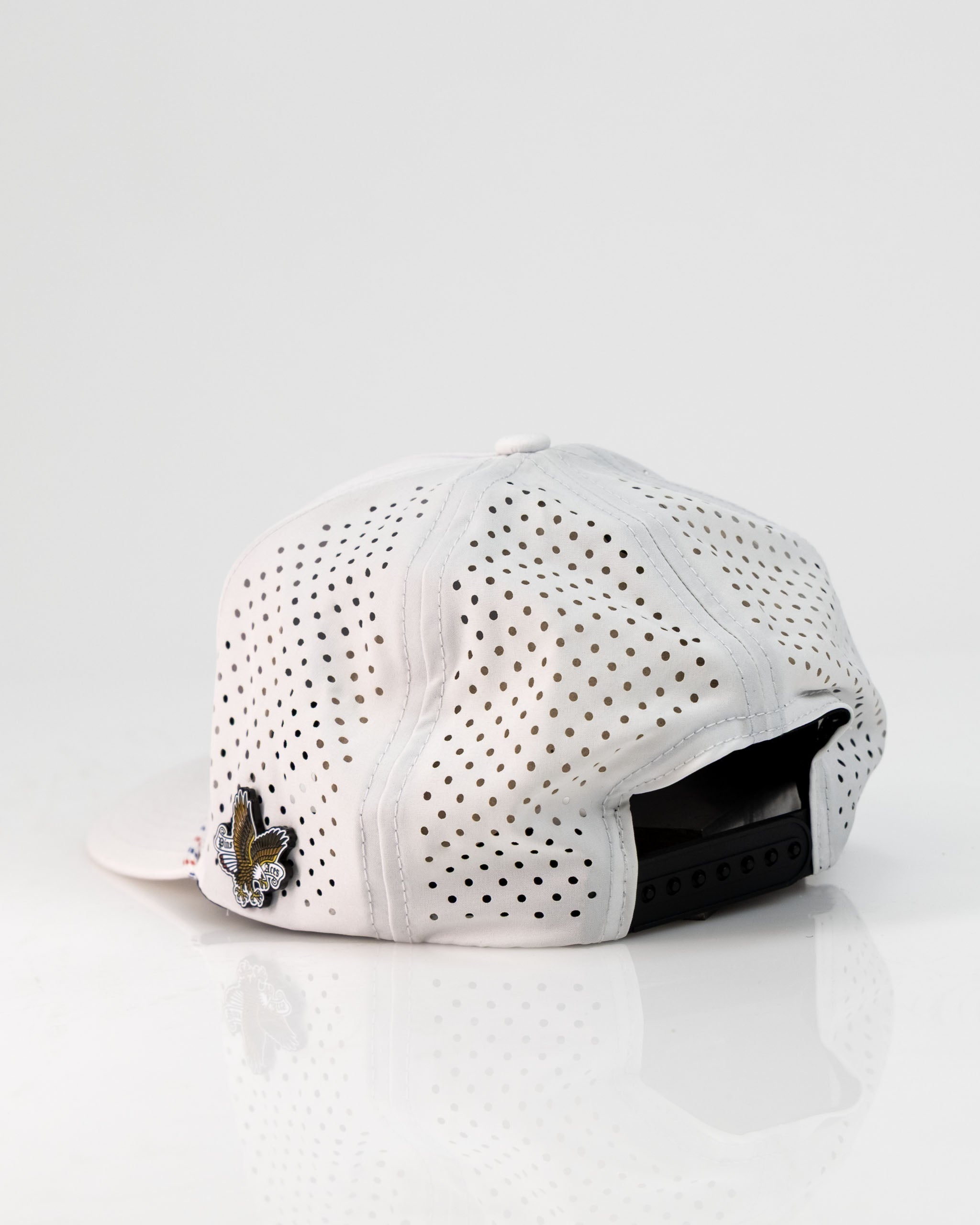 Perforated white rope hat featuring a Freedom Eagle design and adjustable back for a stylish golf accessory.