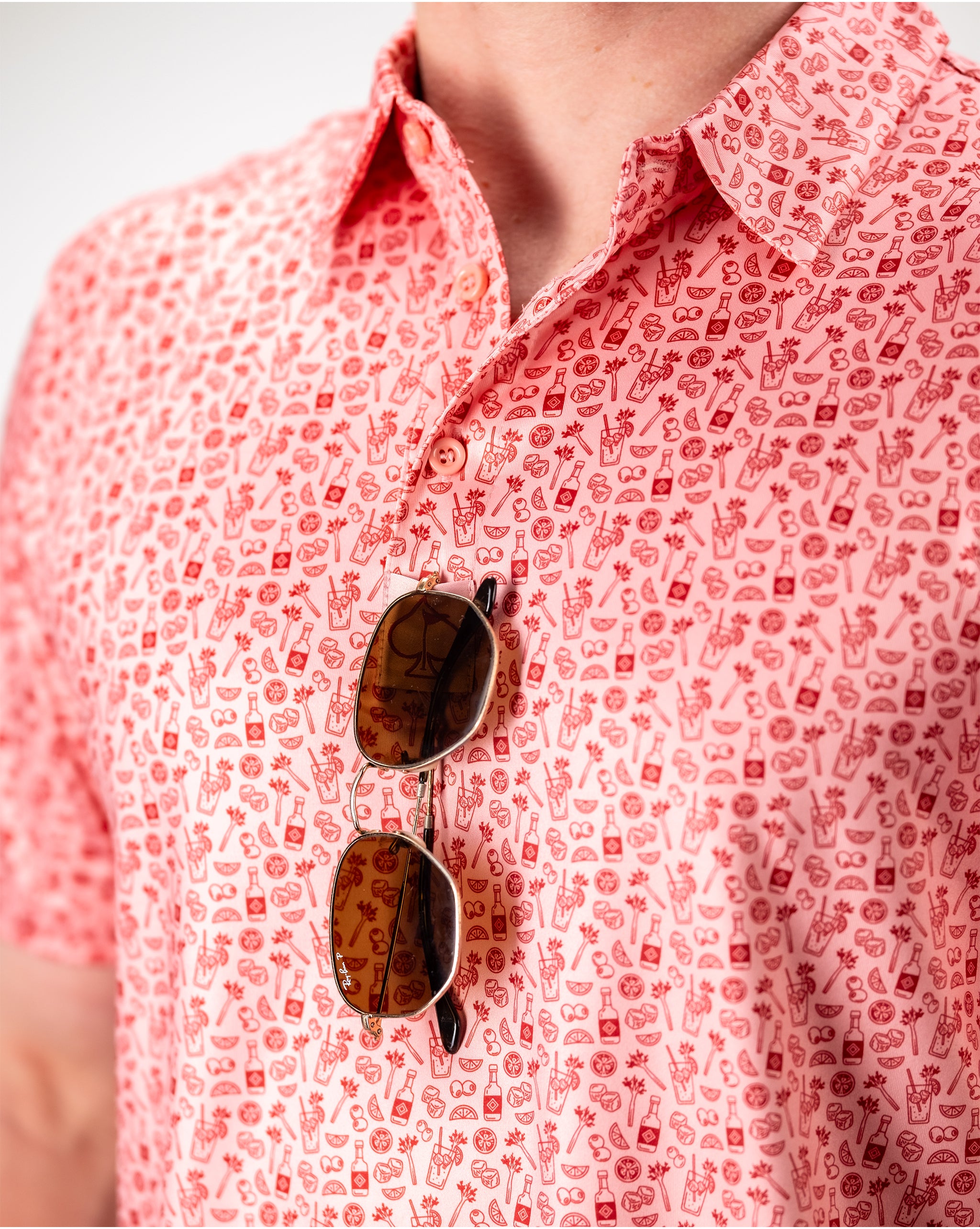 Bloody Mary cocktail with garnishes, served in a glass with a straw, featuring a vibrant red color and decorative toppings.