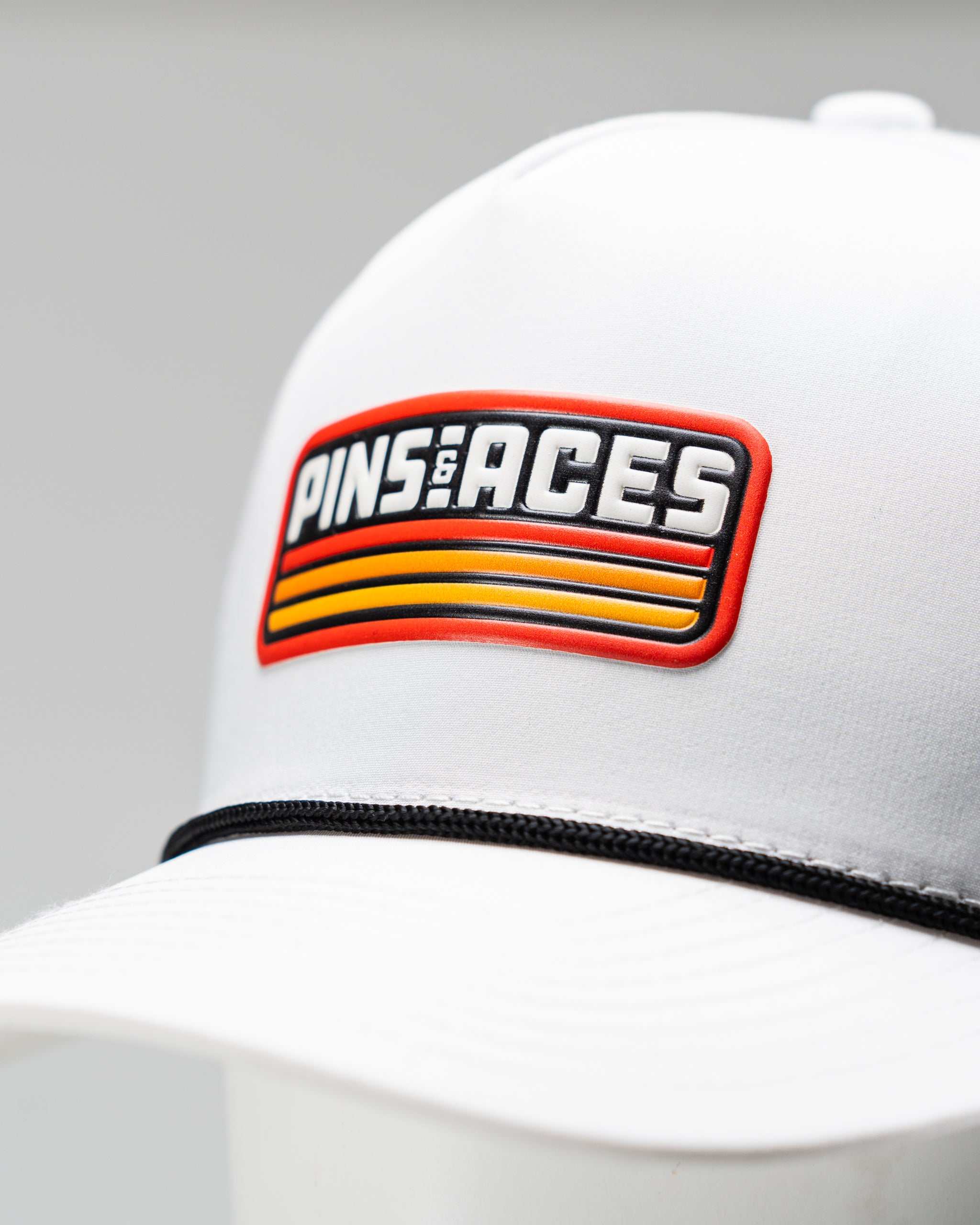 Perforated retro orange rope hat with white accents, featuring a curved brim and adjustable fit.