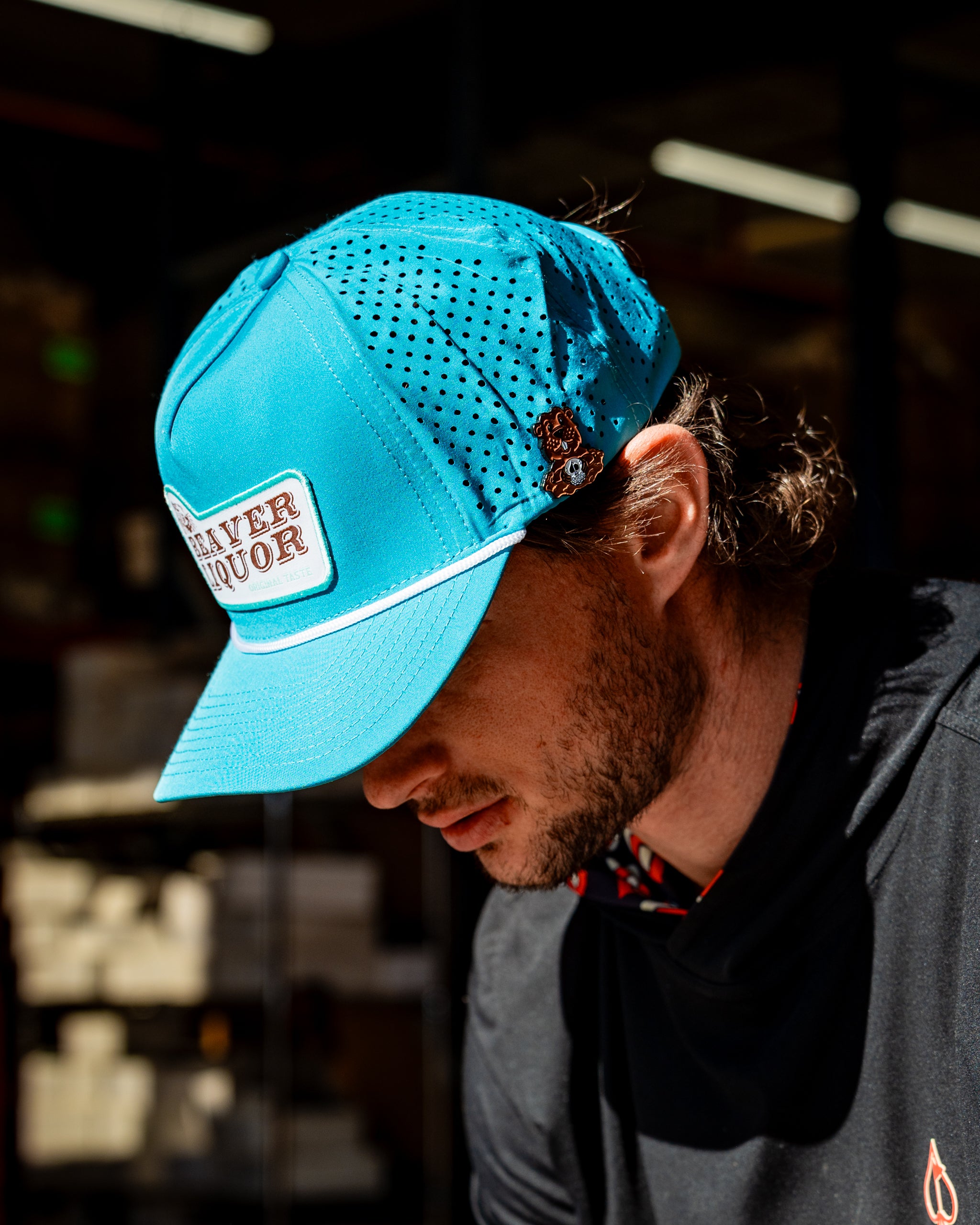 Perforated baby blue rope hat featuring Beaver Liquor logo, ideal for outdoor activities.