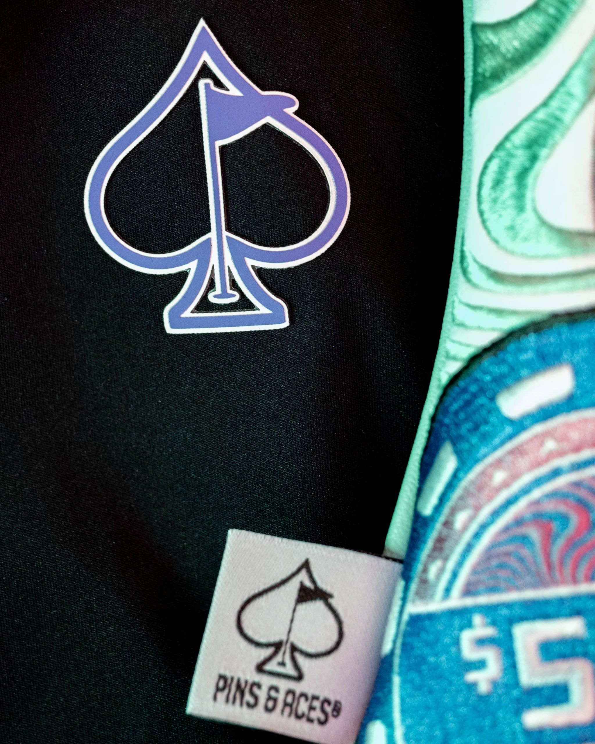 Mystery Box Backpack featuring a bold spade logo and unique design elements for stylish golfers.