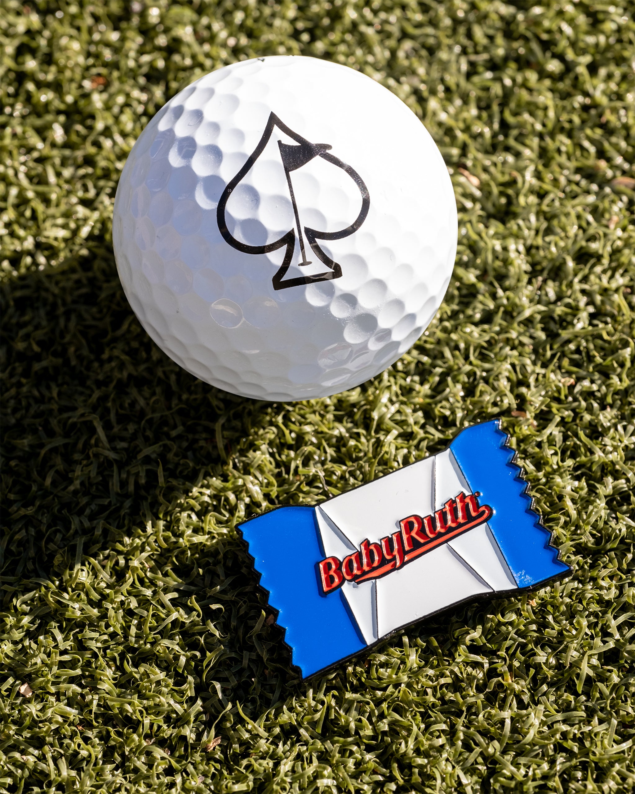 Baby Ruth® ball marker featuring a colorful design with the brand logo, ideal for golf enthusiasts.