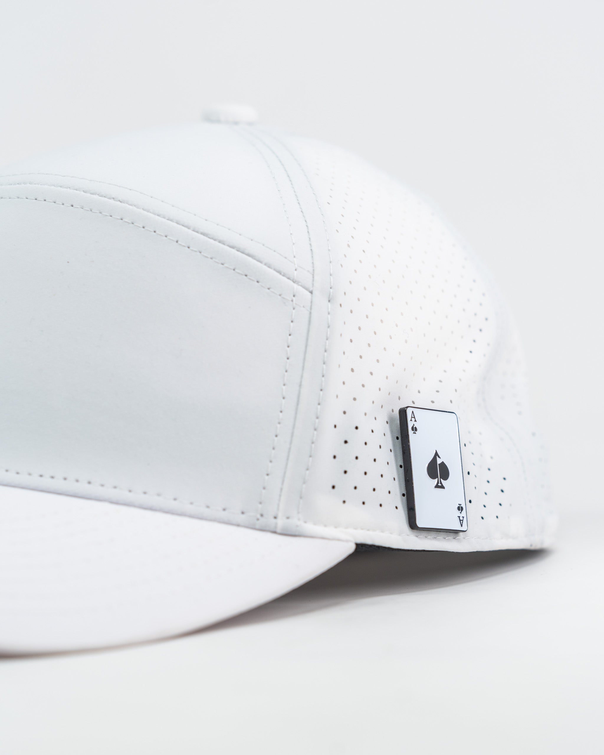 White Tradesman Hat with "Space Golfer" graphic design, featuring a curved brim and adjustable strap.