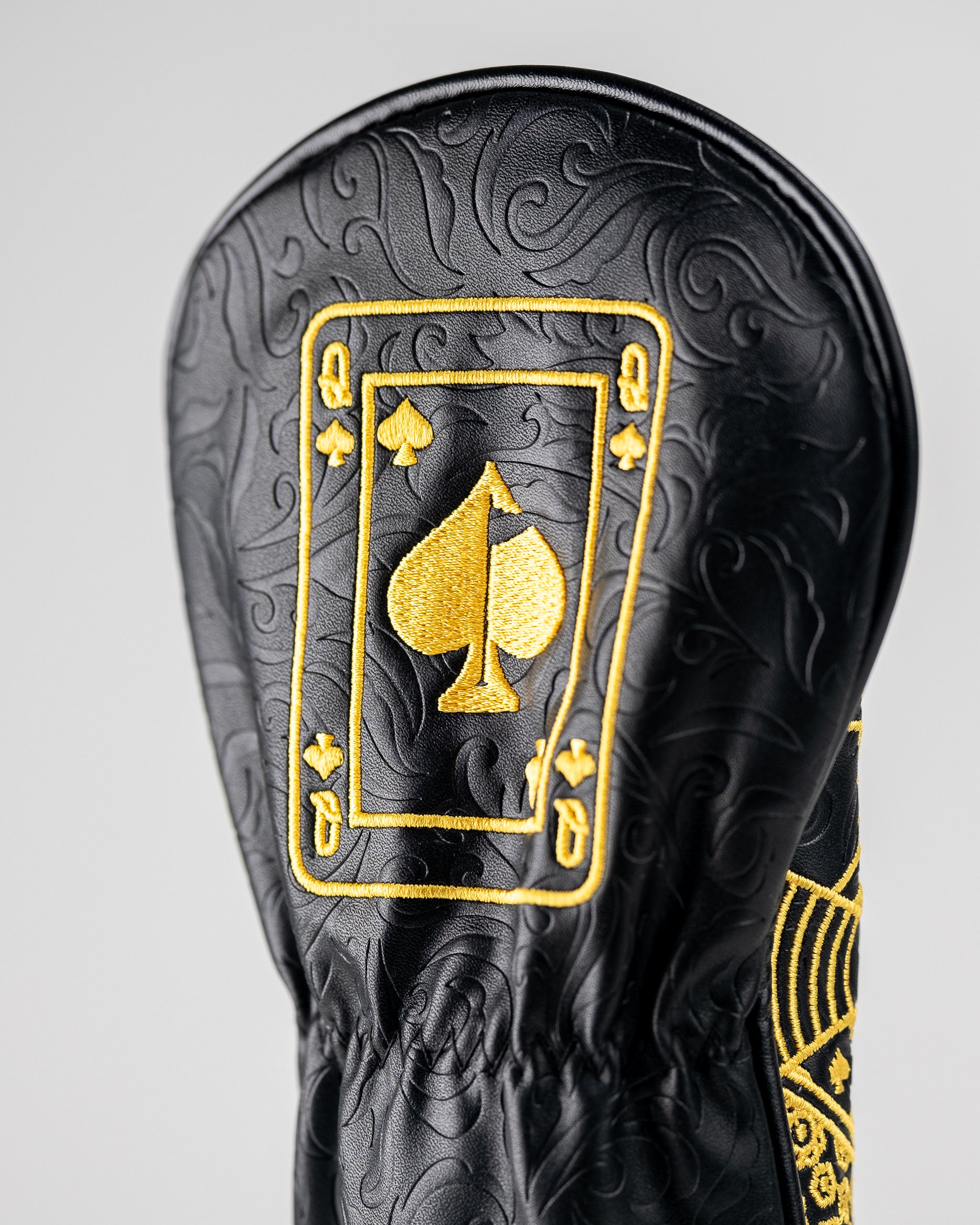 Black and gold Queen of Spades fairway cover with a sleek design and embroidered card symbol.