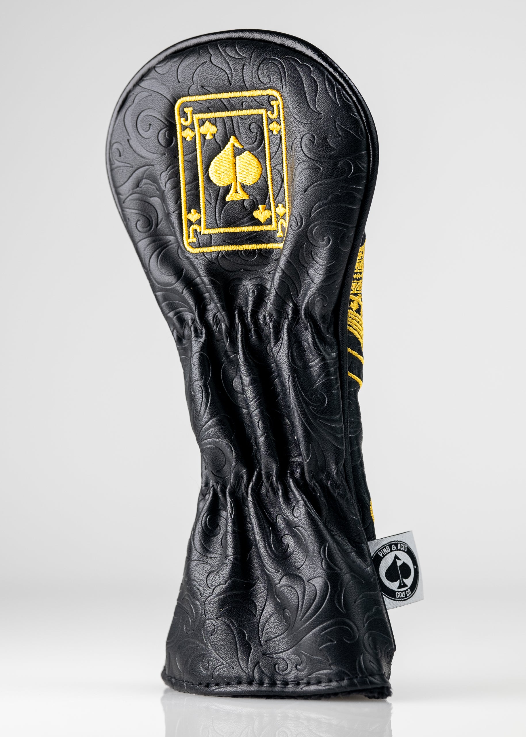 Black and gold Jack of Spades hybrid head cover with a sleek design and detailed embroidery.