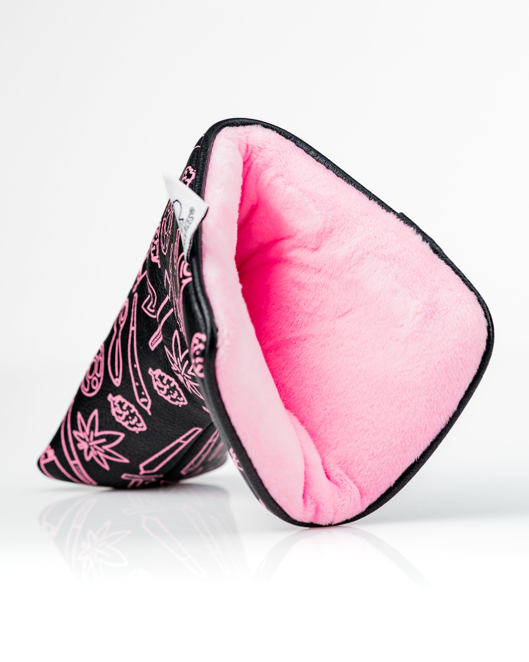 Bold black blade putter cover featuring vibrant pink interior, designed for golfers seeking unique style on the course.