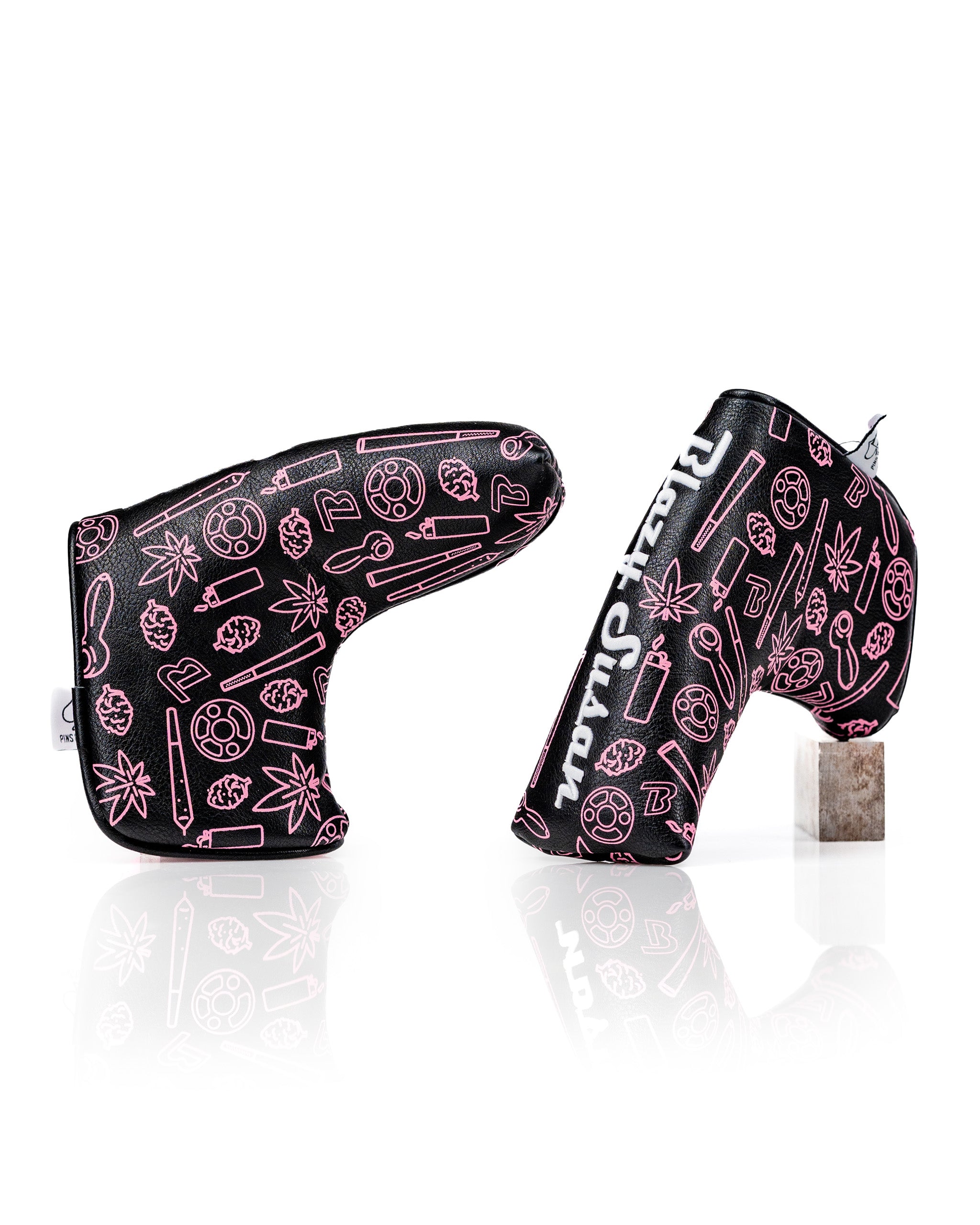 Bold black blade putter cover featuring vibrant pink graphics and unique designs, perfect for stylish golfers.