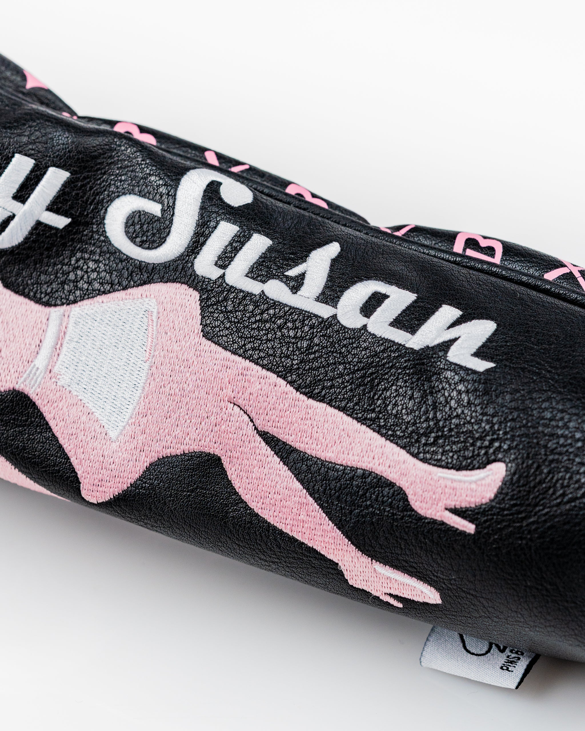 Bold black fairway cover featuring playful pink graphics and the name "Blazy Susan," designed for stylish golfers.