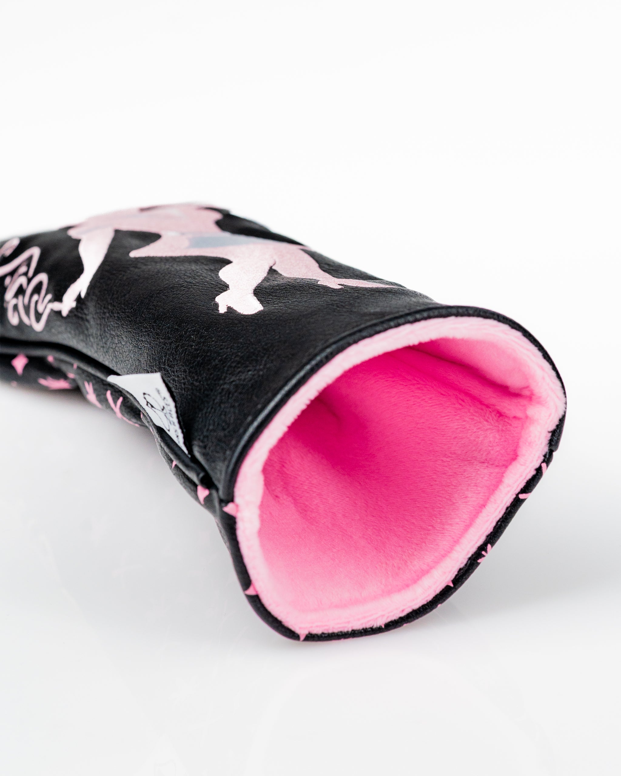 Bold black fairway cover featuring playful pink designs and a soft pink interior, perfect for stylish golfers.