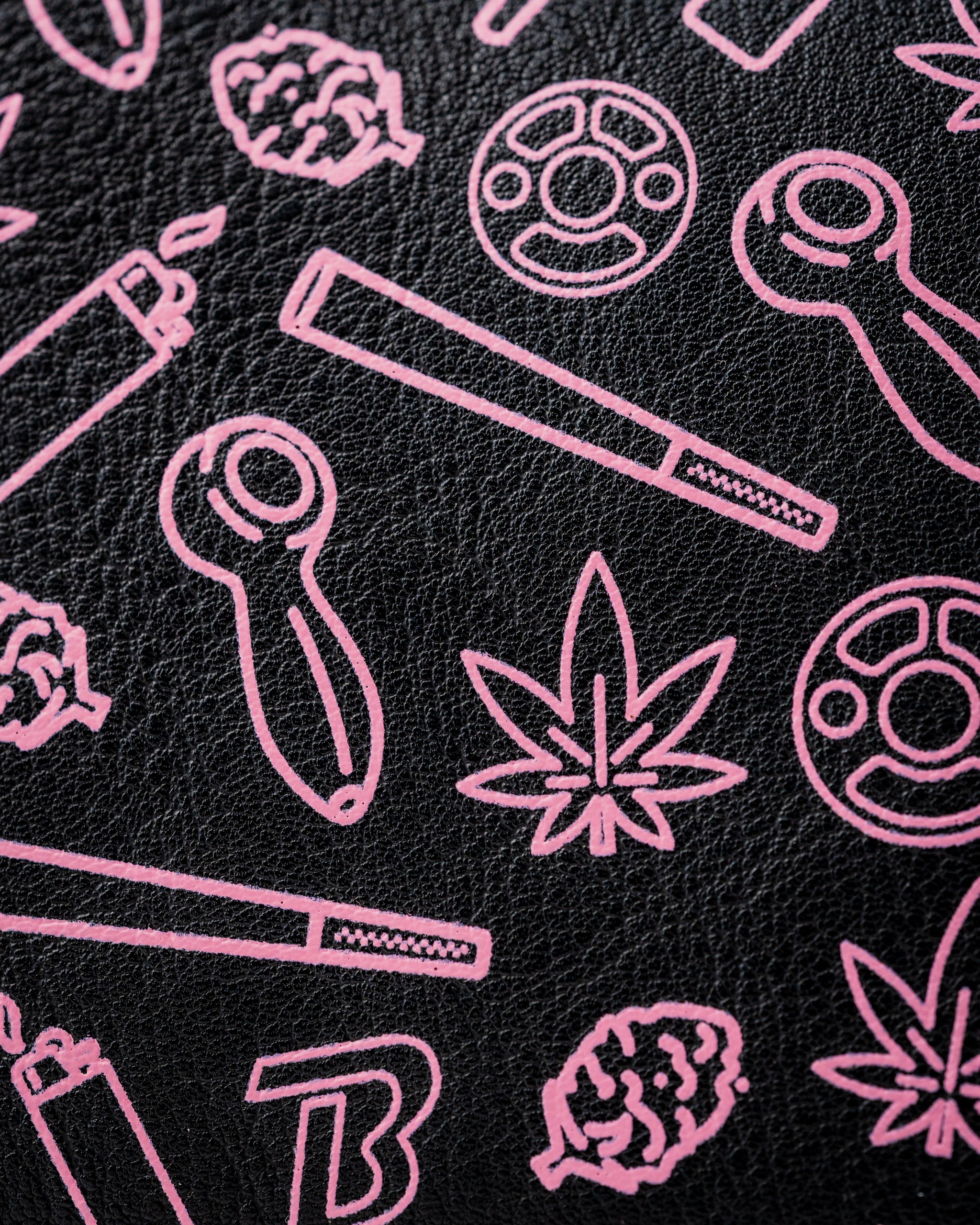 Bold black mallet putter cover featuring playful pink graphics of smoking accessories and cannabis leaves. Perfect for standout golfers.
