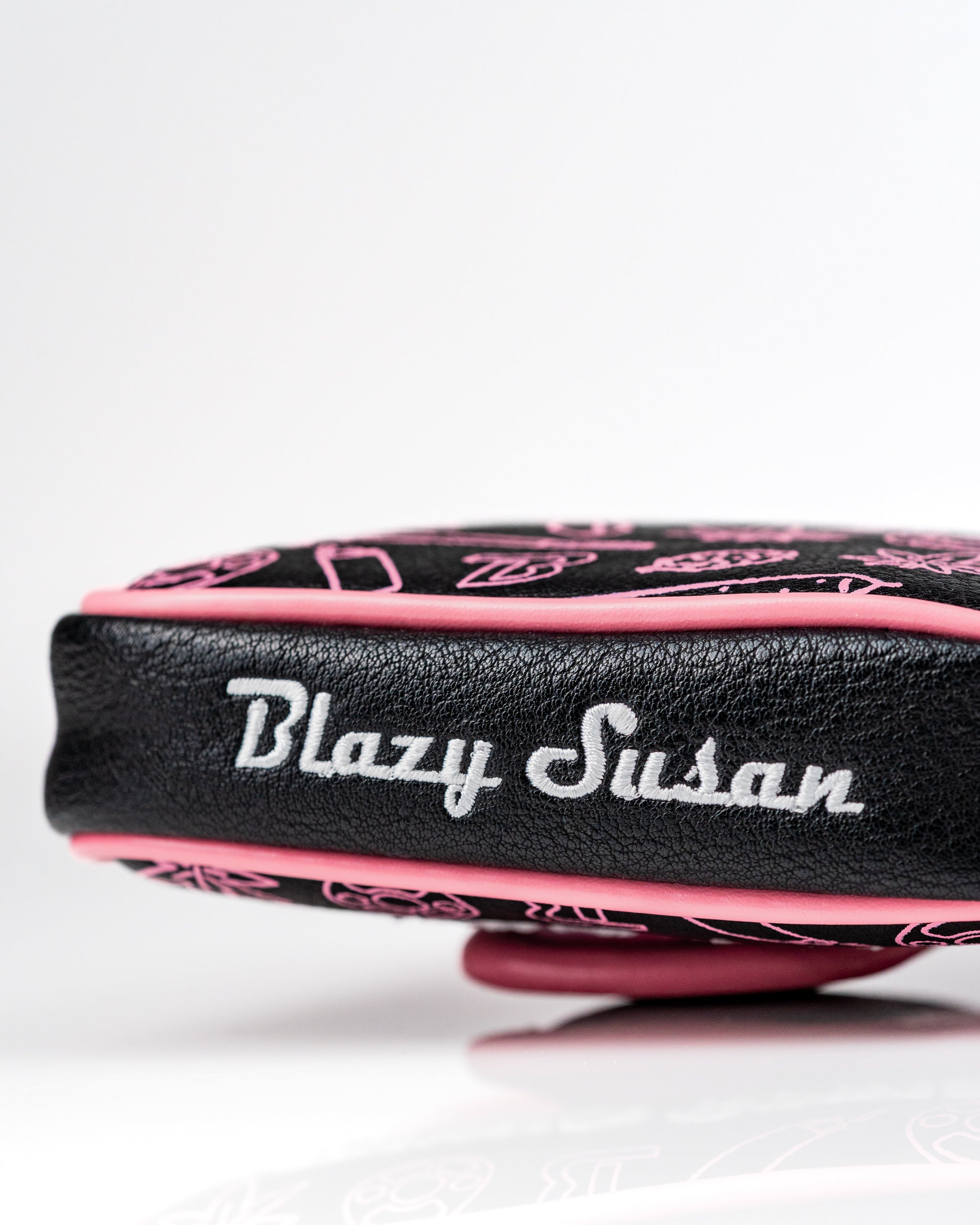 Bold mallet putter cover featuring a black and pink design with "Blazy Susan" embroidered, perfect for stylish golfers.