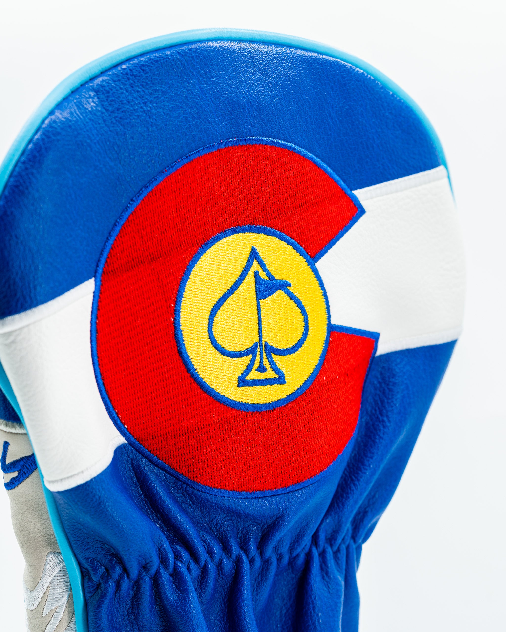 Blue and white driver cover featuring a Colorado-themed design with a spade symbol in the center.