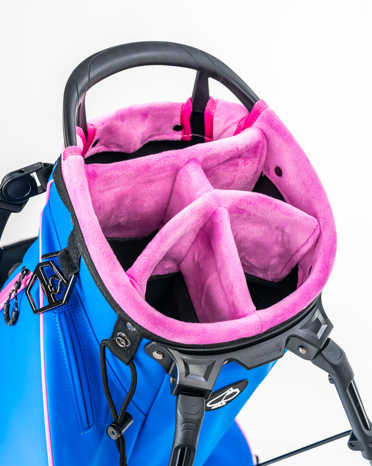 Blue Raspberry golf bag interior featuring a soft pink lining and multiple compartments for organized club storage.