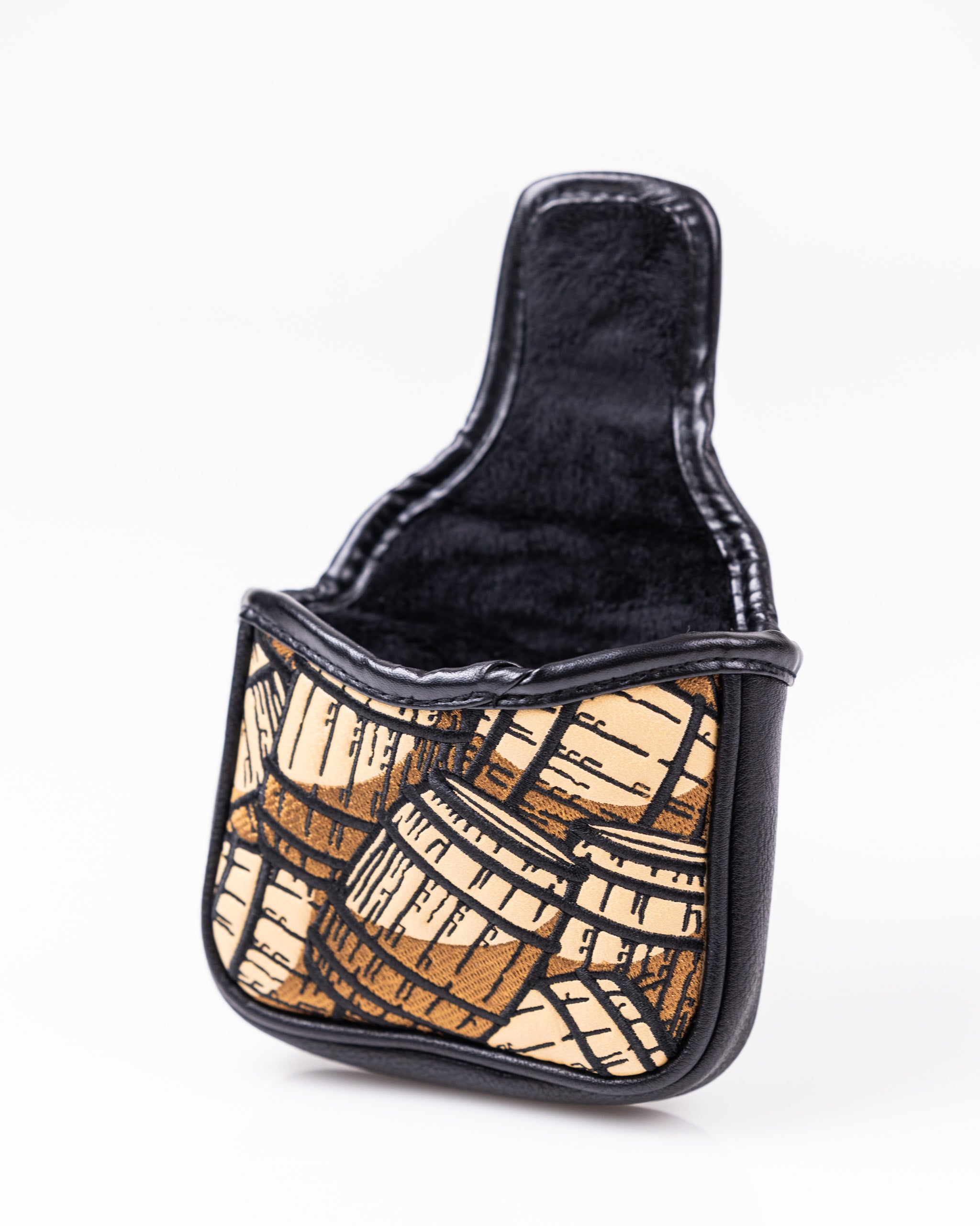 Bold golf headcover with a map-inspired tan and black design, featuring leather accents for standout style on the course.