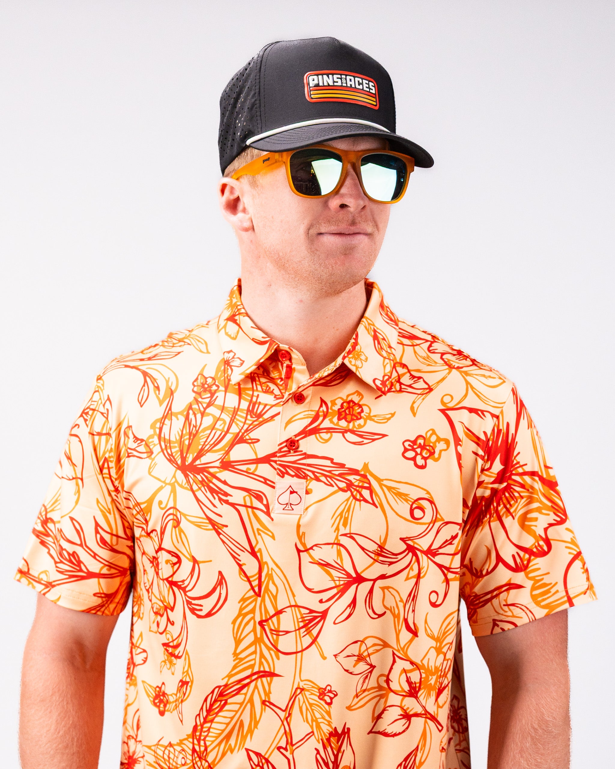 Cabo Sunburst polo shirt featuring vibrant, sunburst-colored pattern and classic collar design.
