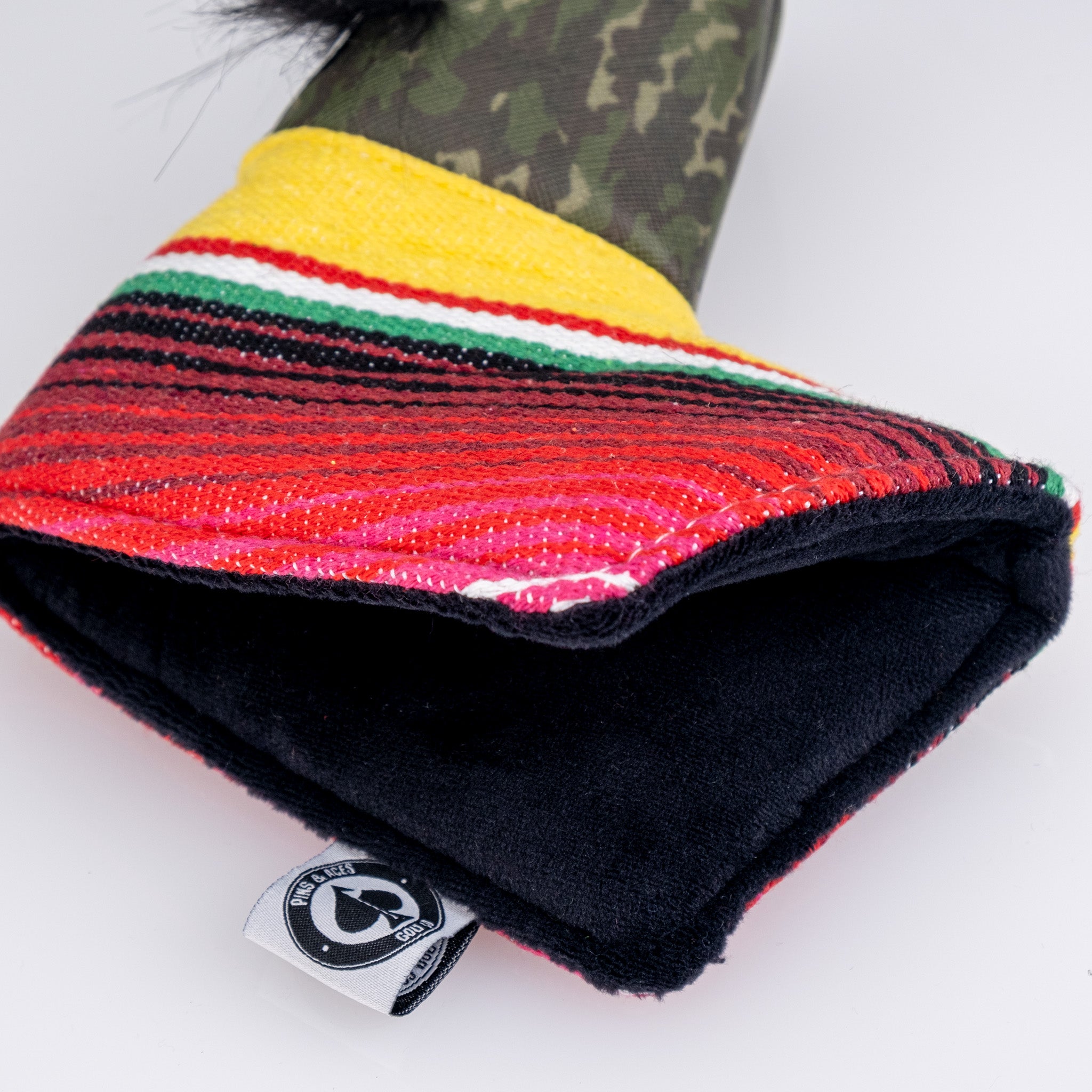 Colorful striped golf headcover with yellow, red, green, and black accents, featuring bold, unique design for standout style.