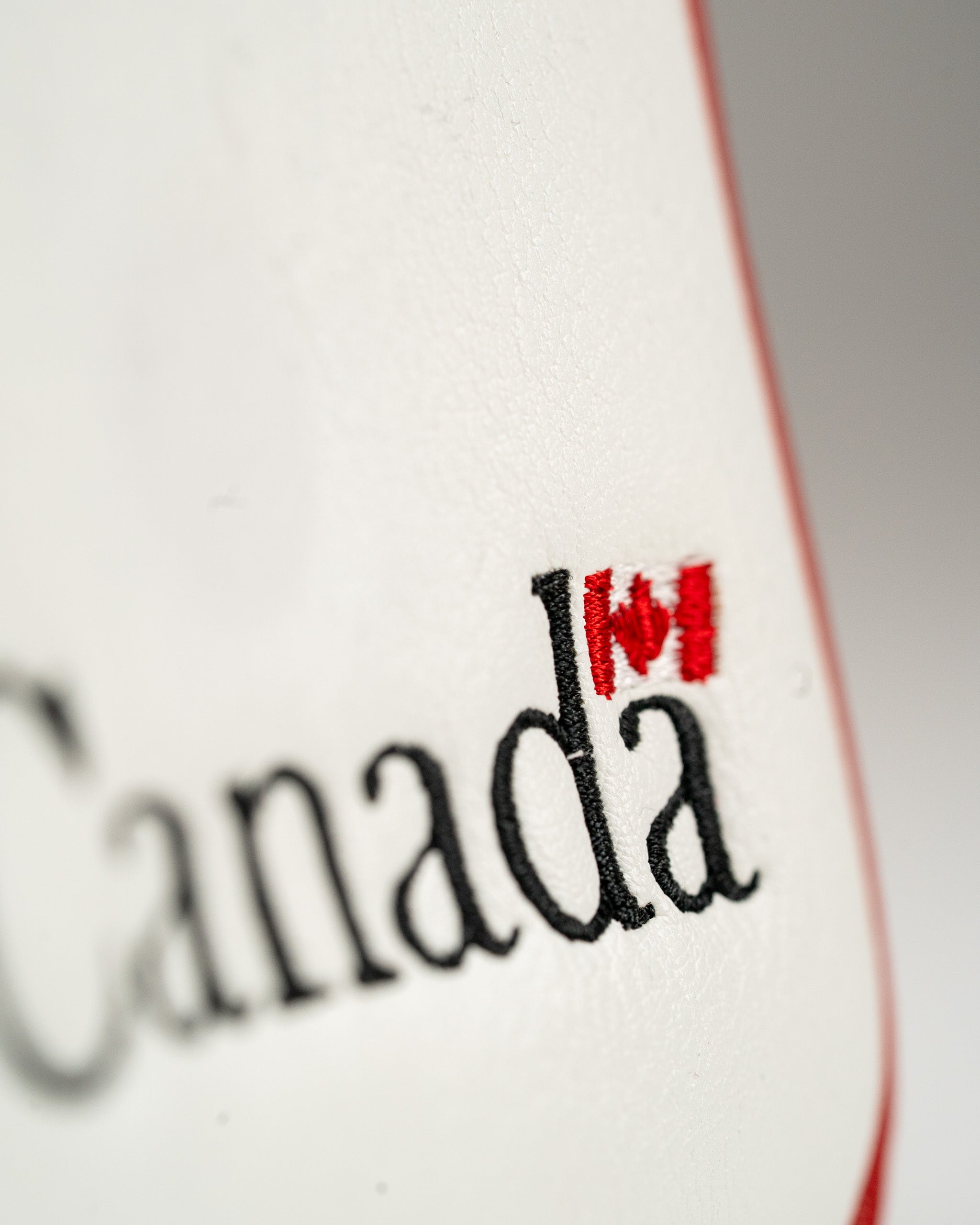 Close-up of a Canada mallet putter cover featuring embroidered text and a red maple leaf design.