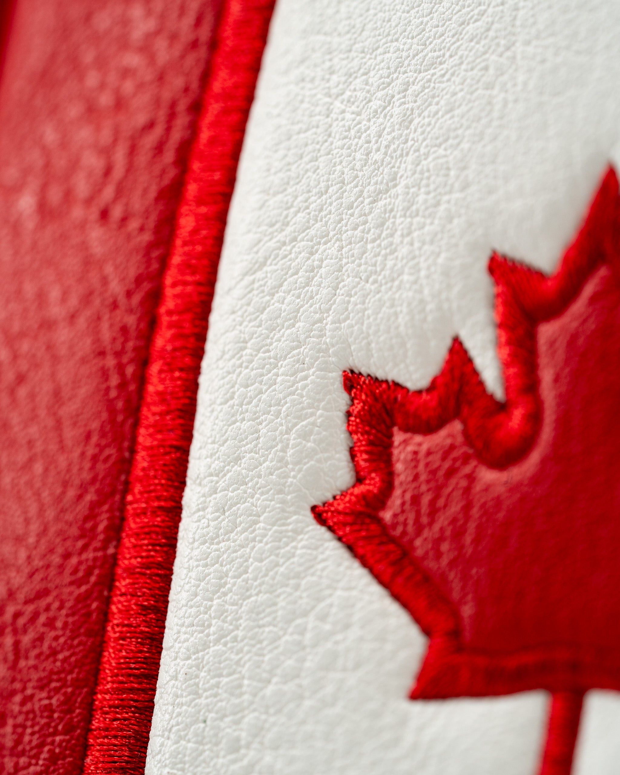 Red and white mallet putter cover featuring an embroidered Canadian maple leaf design, perfect for patriotic golfers.