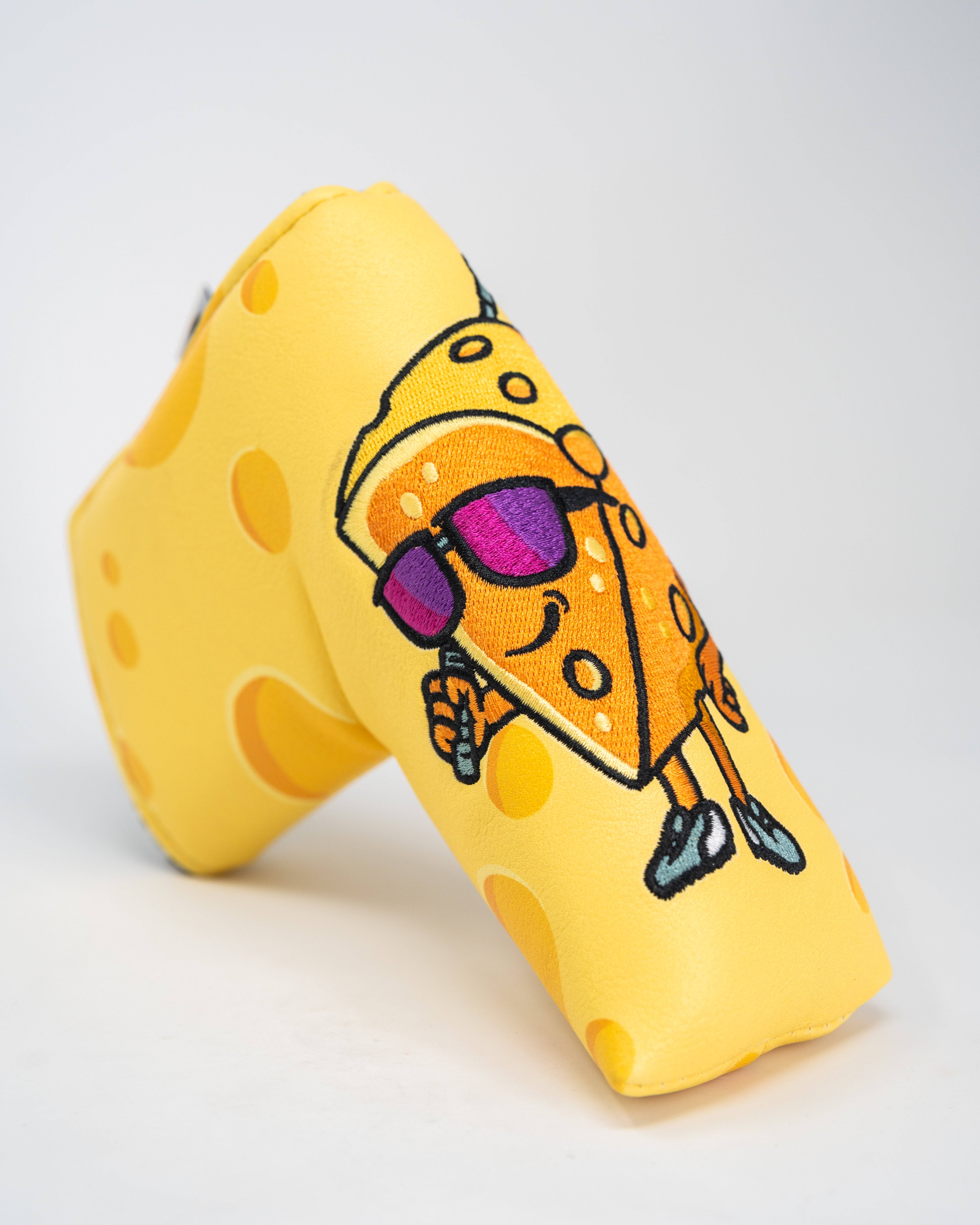Alt text: Big Cheese Blade Putter Cover featuring a fun cheese design, suitable for standard blade putters, showcasing vibrant colors and a durable exterior.
