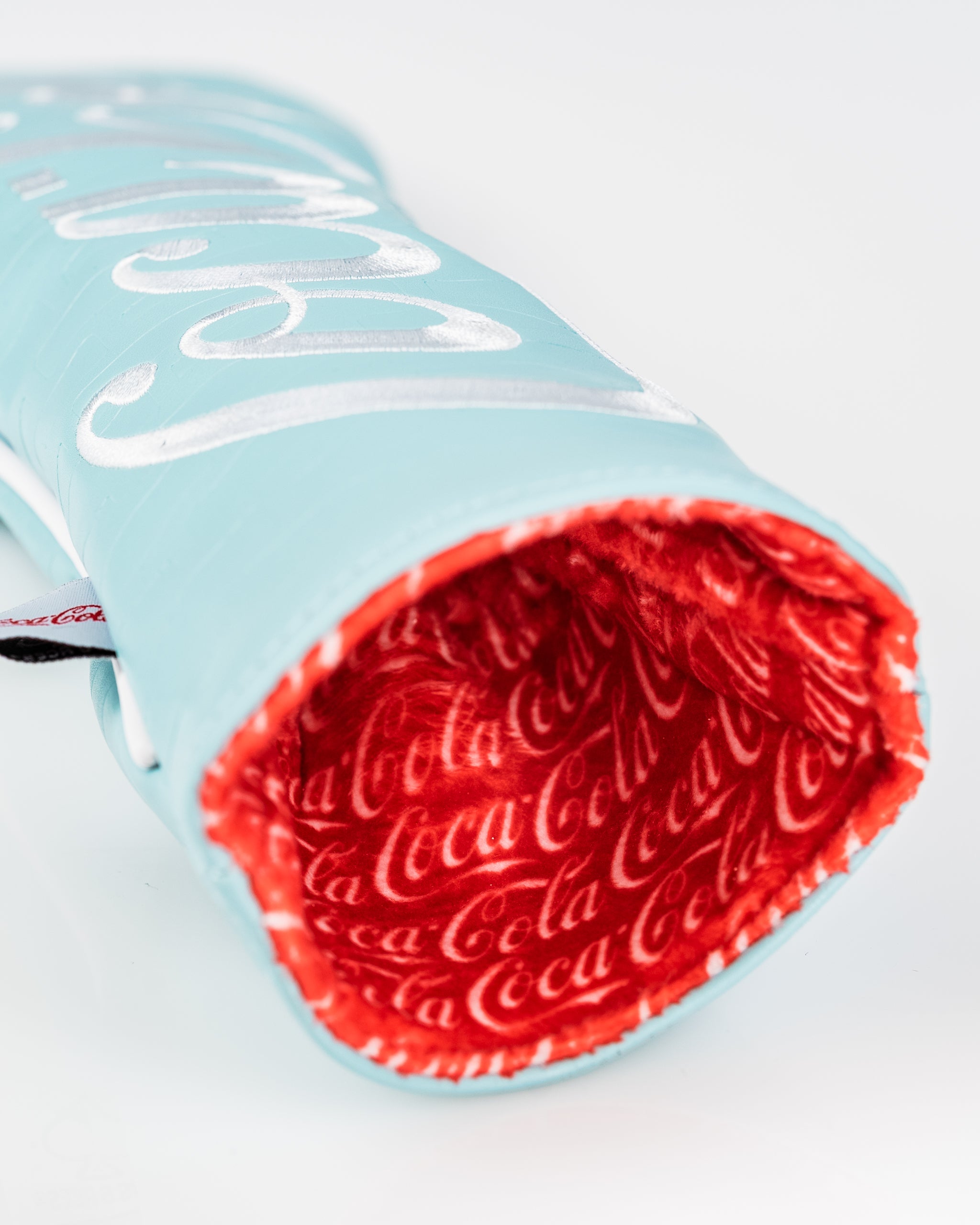 Coca-Cola themed fairway cover featuring a vibrant blue exterior and red interior with repeating logo pattern.