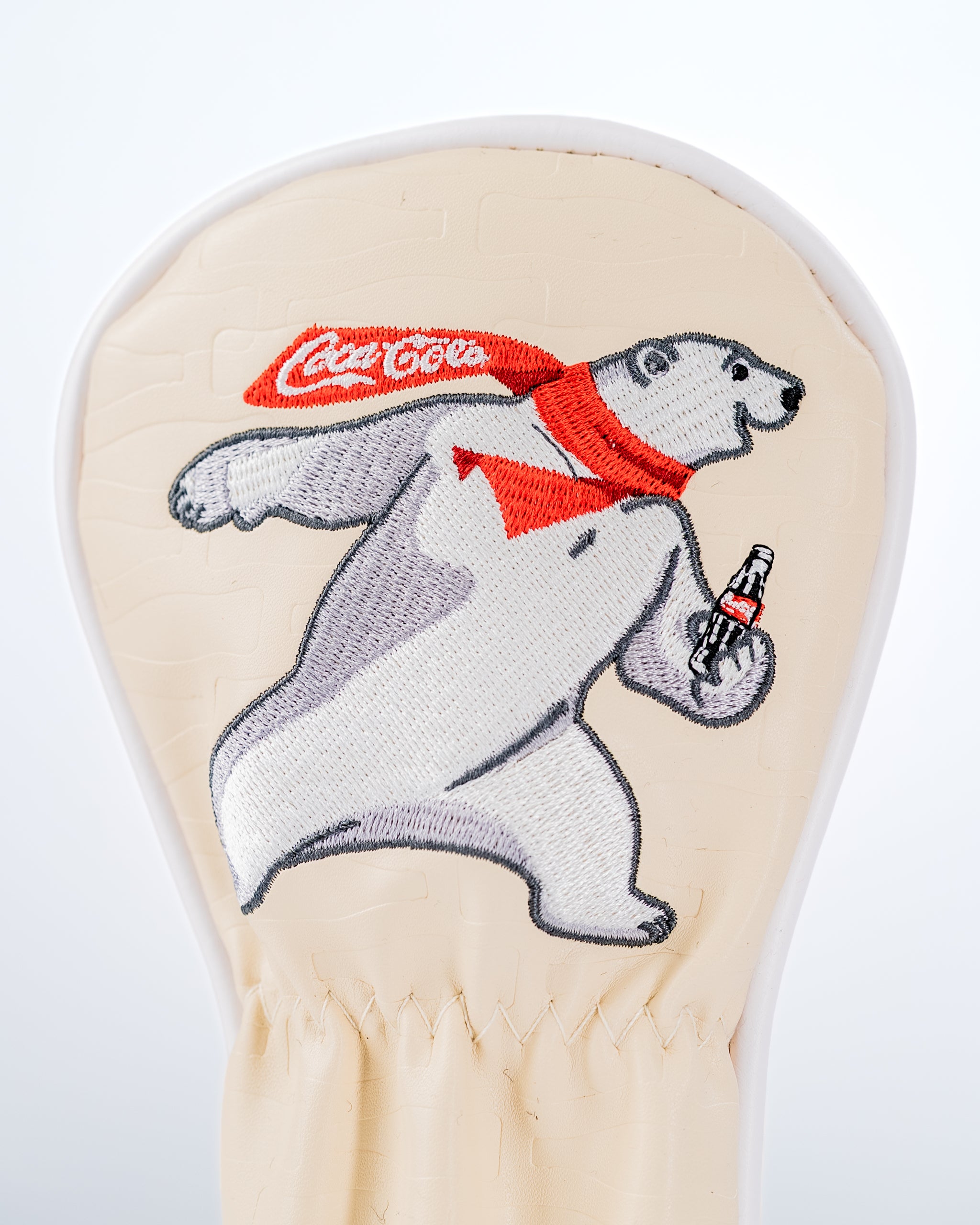 Coca-Cola hybrid golf headcover featuring a playful polar bear holding a bottle of Coke, designed for bold golfers.